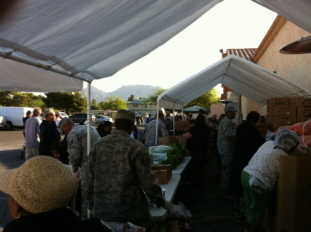 Nellis Air Force Base personnel volunteer at a food bank held at Living Faith Assembly to distributes food to community members Oct. 26, 2011. (Courtesy photo)