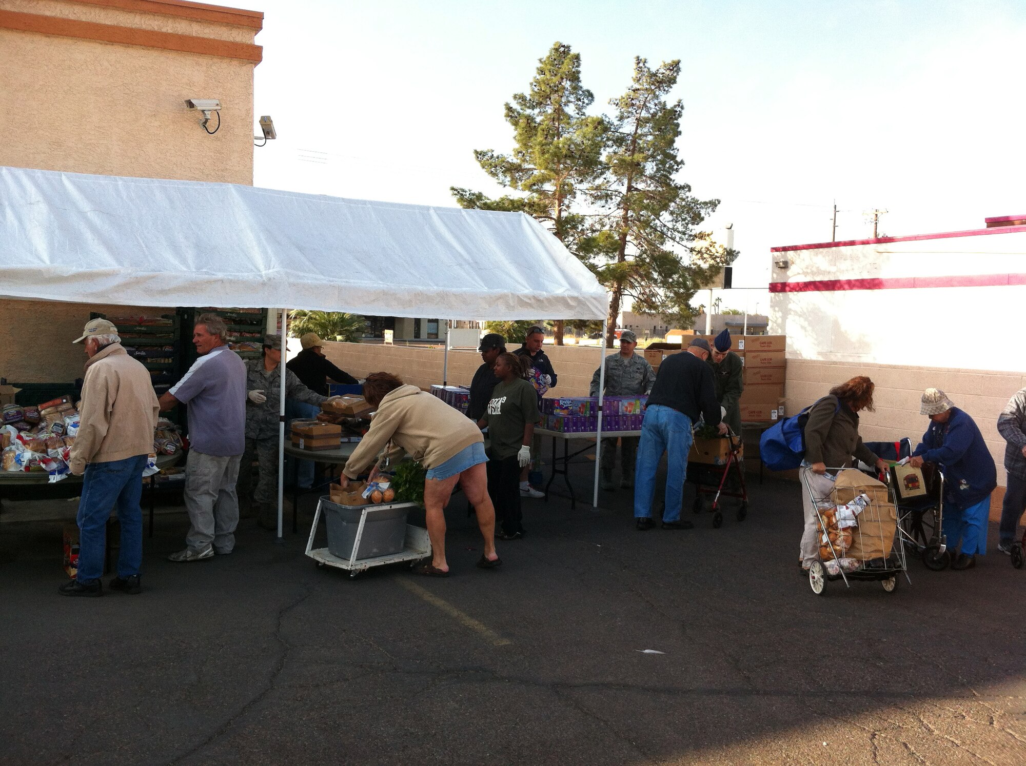 Nellis Air Force Base personnel volunteer at a food bank held at Living Faith Assembly to distributes food to community members Oct. 26, 2011. (Courtesy photo)