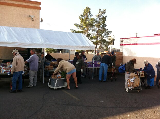 Nellis Air Force Base personnel volunteer at a food bank held at Living Faith Assembly to distributes food to community members Oct. 26, 2011. (Courtesy photo)