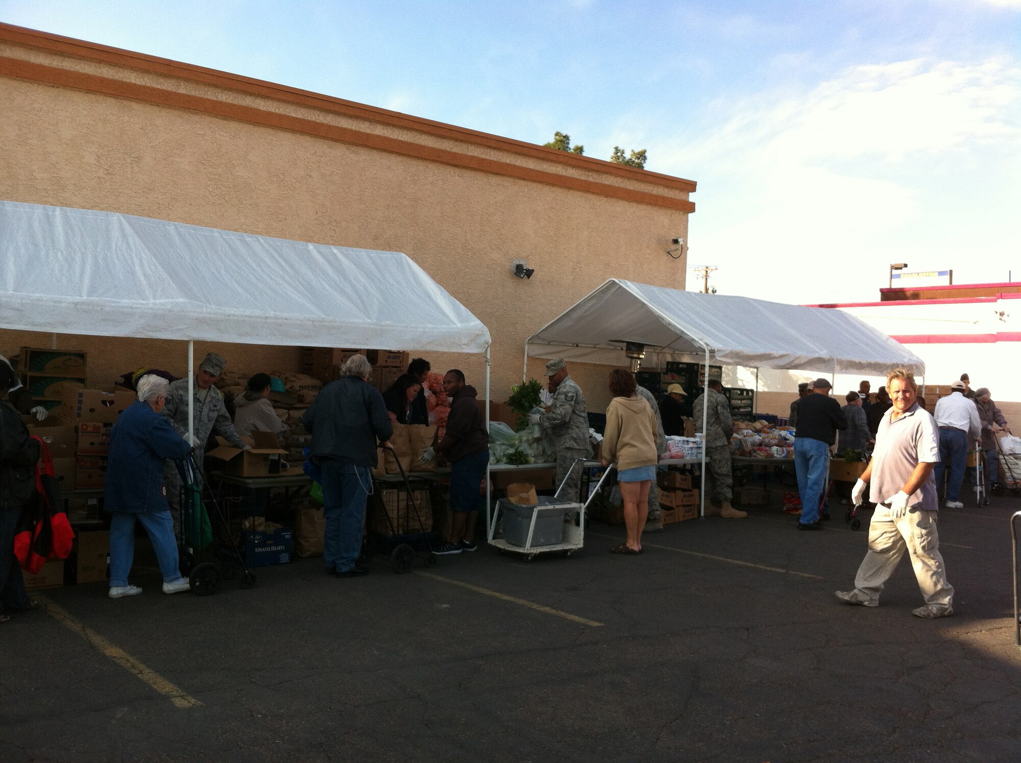Nellis Air Force Base personnel volunteer at a food bank held at Living Faith Assembly to distributes food to community members Oct. 26, 2011. (Courtesy photo)
