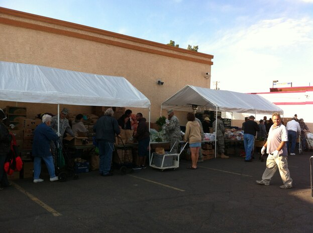 Nellis Air Force Base personnel volunteer at a food bank held at Living Faith Assembly to distributes food to community members Oct. 26, 2011. (Courtesy photo)