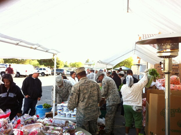 Nellis Air Force Base personnel volunteer at a food bank held at Living Faith Assembly to distributes food to community members Oct. 26, 2011. (Courtesy photo)