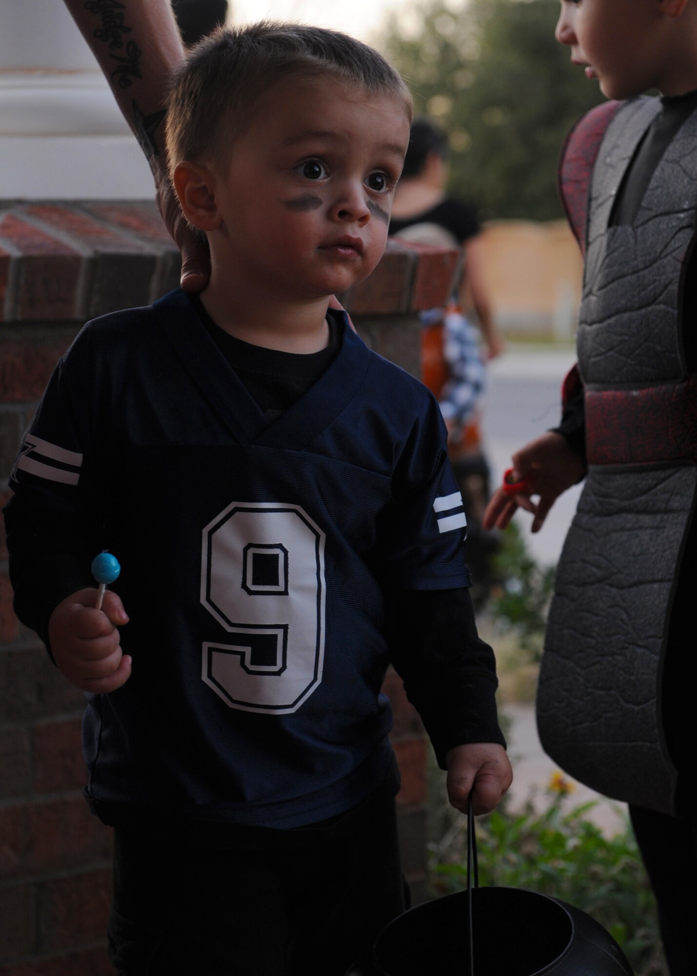 Donvan Sullins, 2, son of Staff Sgt. Clint Sullins, 7th Security Forces Squadron, waits to get candy during Halloween Oct. 31, 2011, at Dyess Air Force Base, Texas. Base housing was open to trick-or-treating from 6-8 p.m. (U.S. Air Force photo by Airman 1st Class Jonathan Stefanko/ Released)