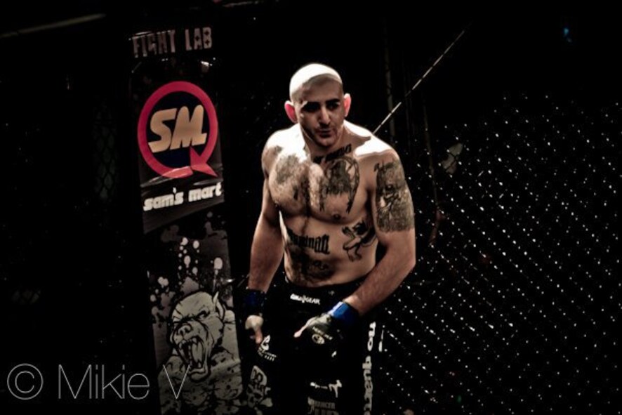 Staff Sgt. Ferdinando Acerra, Staff Sgt. Ferdinando Acerra, 20th Maintenance Operations Squadron, Shaw AFB, S.C., maintenance training flight instructor and Mixed Martial Arts (MMA) fighter, stands in the cage waiting to fight. Acerra will be taking part in the MMA cage fight on Seymour Johnson Air Force Base, N.C., Nov. 4, 2011. Acerra has been fighting for 4 years and will be sporting pink on Nov. 4, in honor of Breast Cancer. (Courtesy photo)