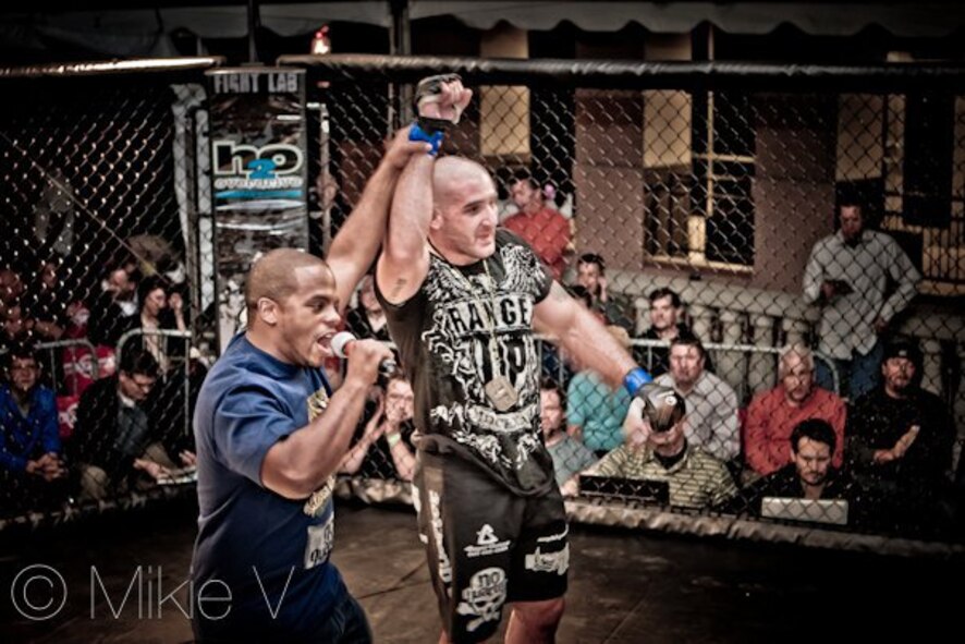 Staff Sgt. Ferdinando Acerra, Staff Sgt. Ferdinando Acerra, 20th Maintenance Operations Squadron, Shaw AFB, S.C., maintenance training flight instructor and Mixed Martial Arts (MMA) fighter, wins a fight. Acerra along with others will be participating in the MMA cage fight on Seymour Johnson Air Force Base, N.C., Nov. 4, 2011. (Courtesy photo)