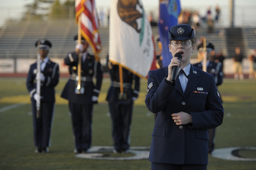 SANTA MARIA, Calif. -- Performing the National Anthem, Senior Airman Danielle Graham, a Vandenberg Patriot Voices singer, sings during the Military Appreciation Night football game at the Righetti High School Stadium Saturday, Oct. 29, 2011. Military members received free admission and food at the game, which pitted the Bulldogs against the Ventura College Pirates. (U.S. Air Force photo/Staff Sgt. Andrew Satran) 