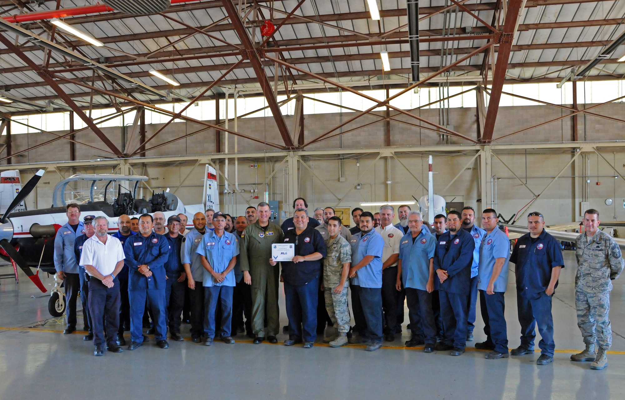 LAUGHLIN AIR FORCE BASE, Texas - Mr. Juan Sandoval, 47th Maintenance Directorate, poses with Col. James Jinnette, 47th Flying Training Wing vice commander, after being presented the XLer of the week award here Oct. 19. The Xler is a weekly award chosen by wing leadership and given to those who consistently make outstanding contributions to Laughlin and their unit. (U.S. Air Force photo/Senior Airman Scott Saldukas)
