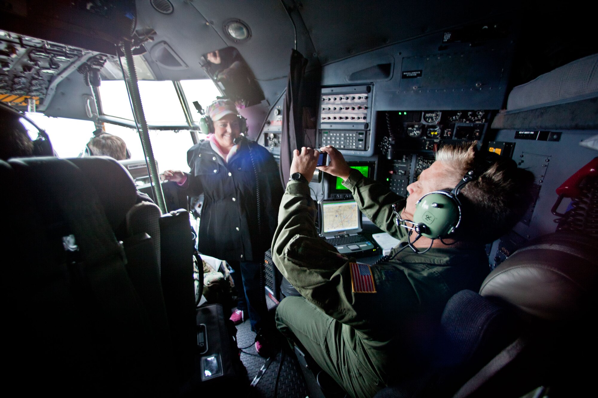 Lisa Engelking has her photo taken on the flight deck by Lt. Col. Mike Erickson, C-130 navigator.(Air Force Photo/Shannon McKay)