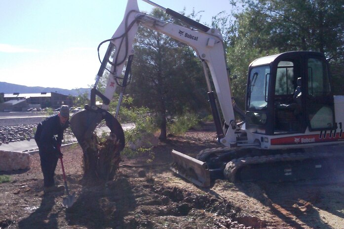 Staff Sgt. Kory Meda, 99th Civil Engineer Squadron Environmental Section member, clears an area Oct. 27, 2011, at the Maj. Gen. Billy McCoy Environmental Grove on Nellis Air Force Base, Nev.  The grove was part of the initial trend in the Las Vegas area to incorporate desert landscape with the intention to conserve energy and water resources. (Courtesy photo)