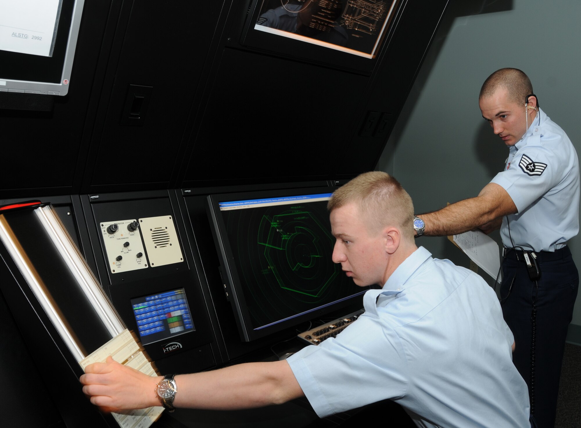 Airman Basic Trevor Pinkston and his instructor, Staff Sgt. Nick Volz, 334th Training Squadron, use  the new radar approach control simulator system for training Oct. 31, 2011, in Cody Hall at Keesler Air Force Base, Miss.  The system, designed by the 81st Training Support Squadron's trainer development flight, features a touch entry display platform to replicate a real-world Air Traffic Control communications console at a significantly lower cost than an actual console.  (U.S. Air Force photo by Kemberly Groue)