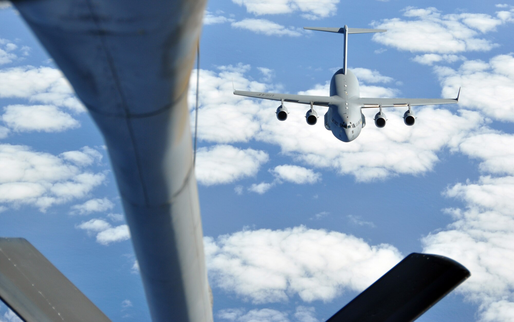 A KC-135 Stratotanker deployed with the 313th Air Expeditionary Wing in the European theater of operations prepares to refuel a C-17 Globemaster III over the Atlantic Ocean on Oct. 29, 2011. The C-17 was en route from Tripoli, Libya, to Boston, Mass., to deliver 22 Libyan rebel fighters for medical care at the Spaulding Hospital for Continuing Medical Care North Shore in Salem, Mass. The C-17, assigned to the 172nd Airlift Wing of the Mississippi National Guard, was refueled by a KC-135 from McConnell AFB, Kan., that is normally operated by the 22nd Air Refueling Wing and the 931st Air Refueling Group. The 313th AEW supported NATO's Operation Unified Protector -- the mission that carried out the United Nations' mandate to protect the citizens of Libya. (U.S. Air Force Photo/Maj. Andra Higgs)