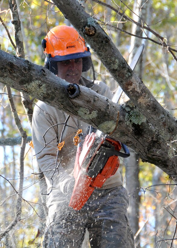 Master Sgt. James Dunn, an aircraft maintenance technician at the 104th Fighter Wing, Westfield Massachusetts, cuts down a tree that is blocking a road in Hampden Massachusetts., on Tuesday, November 1, 2011.  He and more than 50 chainsaw-teams were activated to support clean-up efforts in the state following the unusually snow storm that hit the eastern seaboard Oct 29-30th 2011. (photograph by Maj. Matthew T. Mutti, 104FW/CCE)