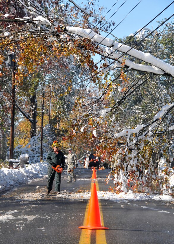 A team of Air National Guard members clear roads in Hampden Massachusetts, following the unusual snow storm that hit the eastern seaboard Oct 29-30, 2011.  More than 50 chainsaw-teams were activated to support clean-up efforts throughout Western Massachusetts. (photograph by Maj. Matthew T. Mutti,
104FW/CCE)