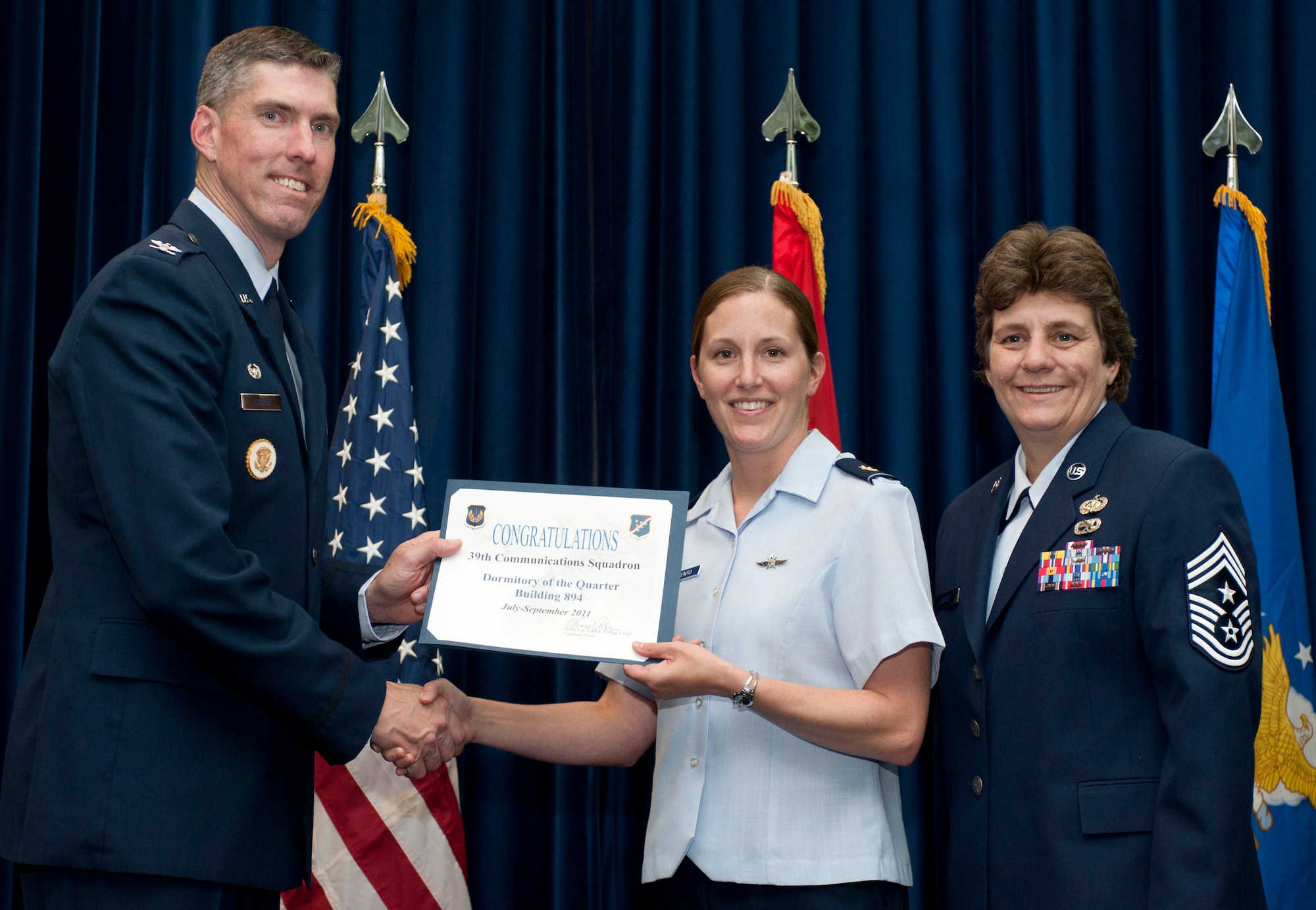 Maj. Traci Sarmiento, 39th Communications Squadron, accepts the Dormitory of the Quarter Award on behalf of the 39th CS Oct. 31, 2011, in the Club Complex ballroom at Incirlik Air Base, Turkey.(U.S. Air Force photo by Senior Airman Clayton Lenhardt/Released)