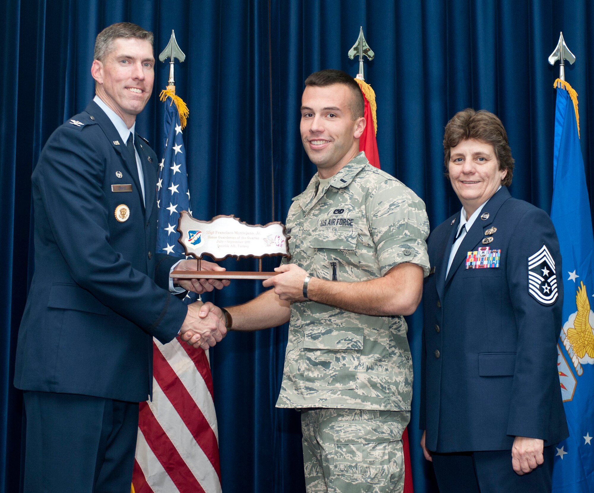 First Lt. Robert Drumm, 39th Maintenance Squadron, accepts the Honor Guardsman of the Quarter Award on behalf of Staff Sgt. Francisco Montejano, 39th MXS, Oct. 31, 2011, in the Club Complex ballroom at Incirlik Air Base, Turkey.(U.S. Air Force photo by Senior Airman Clayton Lenhardt/Released)