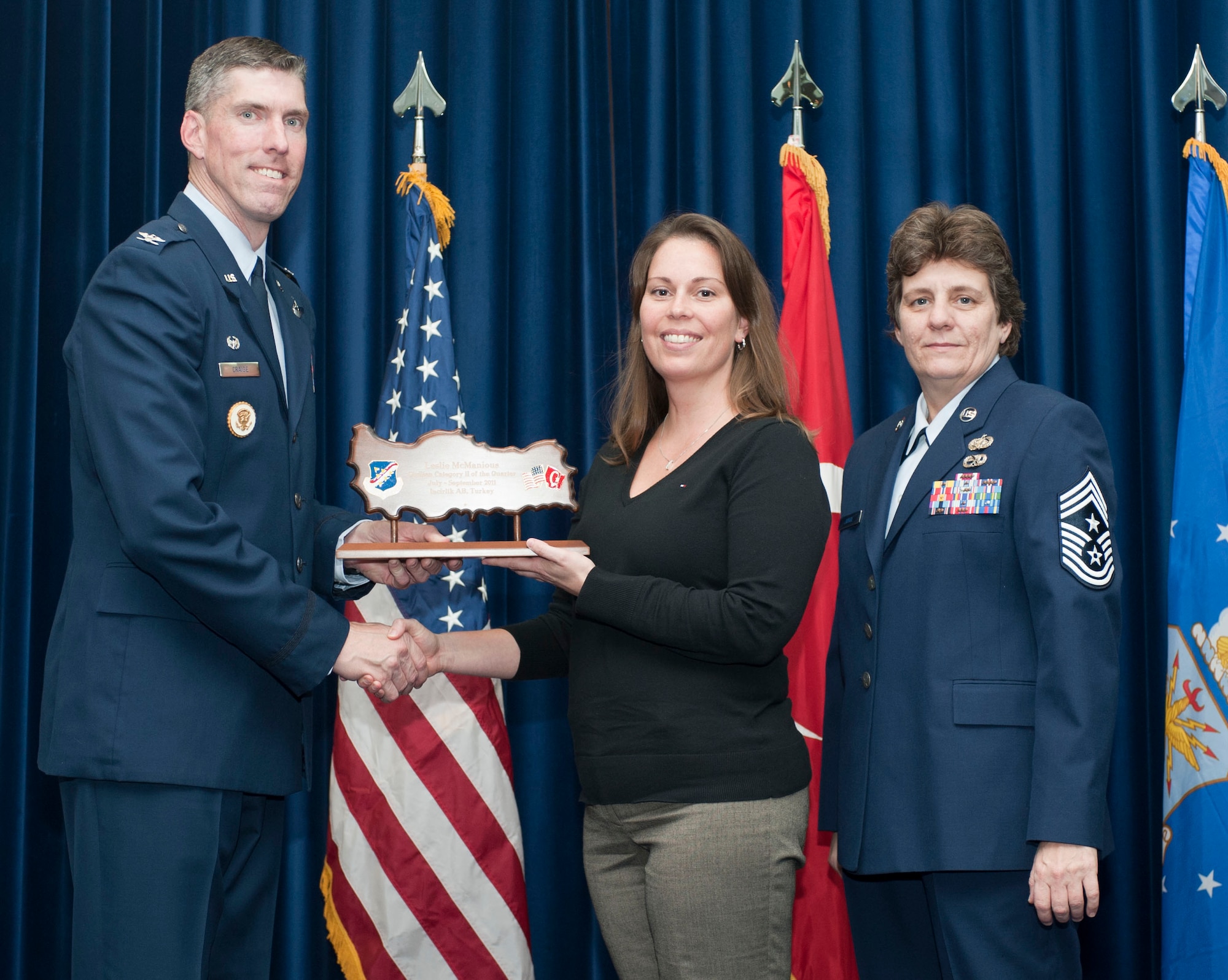 Leslie McManious, 39th Contracting Squadron, receives the wing-level Civilian Category Two of the Quarter Award Oct. 31, 2011, in the Club Complex ballroom at Incirlik Air Base, Turkey.(U.S. Air Force photo by Senior Airman Clayton Lenhardt/Released)