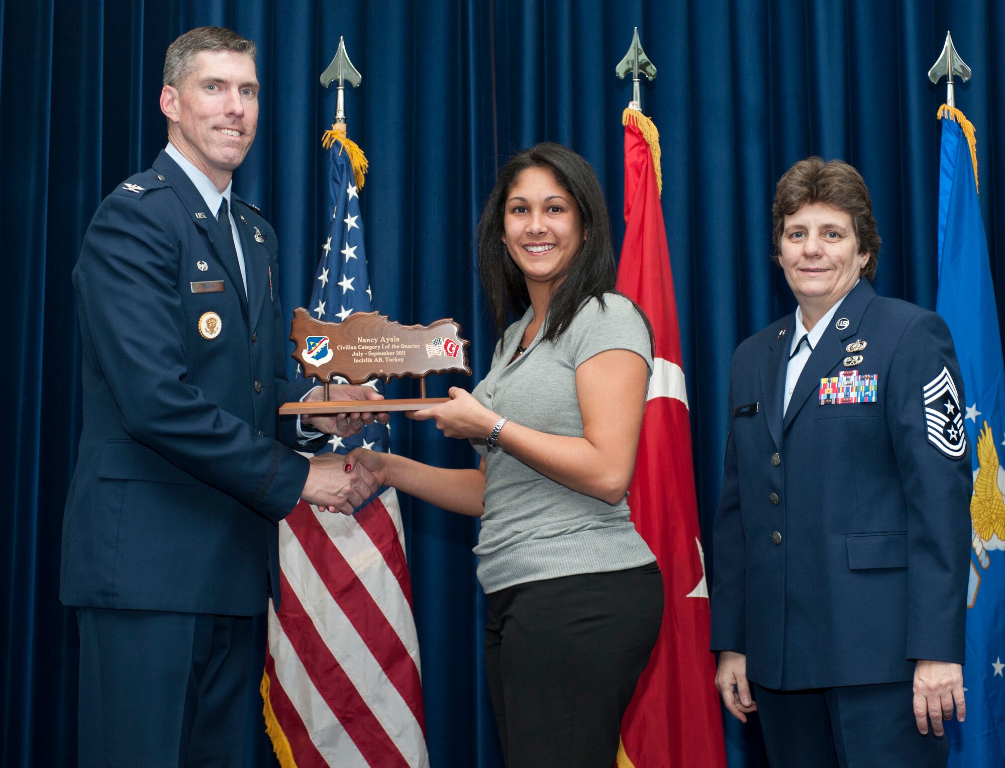 Nancy Ayala, 39th Operations Squadron, receives the wing-level Civilian Category One of the Quarter Award Oct. 31, 2011, in the Club Complex ballroom at Incirlik Air Base, Turkey.(U.S. Air Force photo by Senior Airman Clayton Lenhardt/Released)