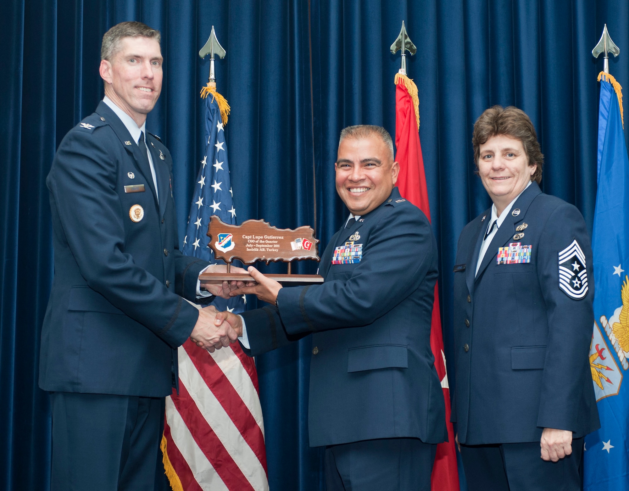 Capt. Lupe Gutierrez, 39th Maintenance Squadron, receives the wing-level Company Grade Officer of the Quarter Award Oct. 31, 2011, in the Club Complex ballroom at Incirlik Air Base, Turkey.(U.S. Air Force photo by Senior Airman Clayton Lenhardt/Released)