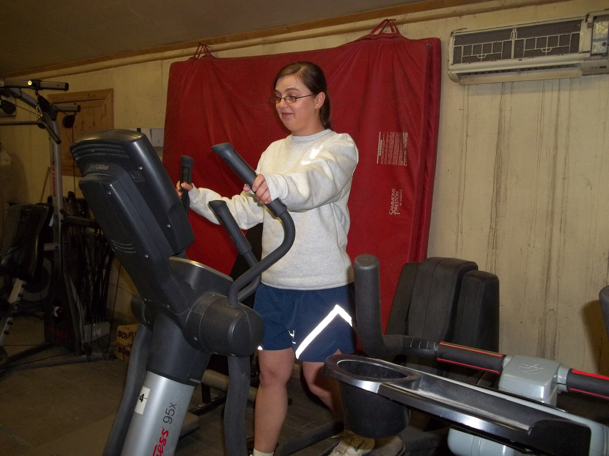 Senior Airman Roza Kowal, Provincial Reconstruction Team Paktya supply specialist from Chicago, works out on an elliptical machine at Bagram Airfield Oct. 28, 2011. When not running, Kowal, opts for other cardio workouts such as the elliptical machine and biking. Since the beginning of her deployment, Kowal has lost more than 40 pounds. (Courtesy photo)