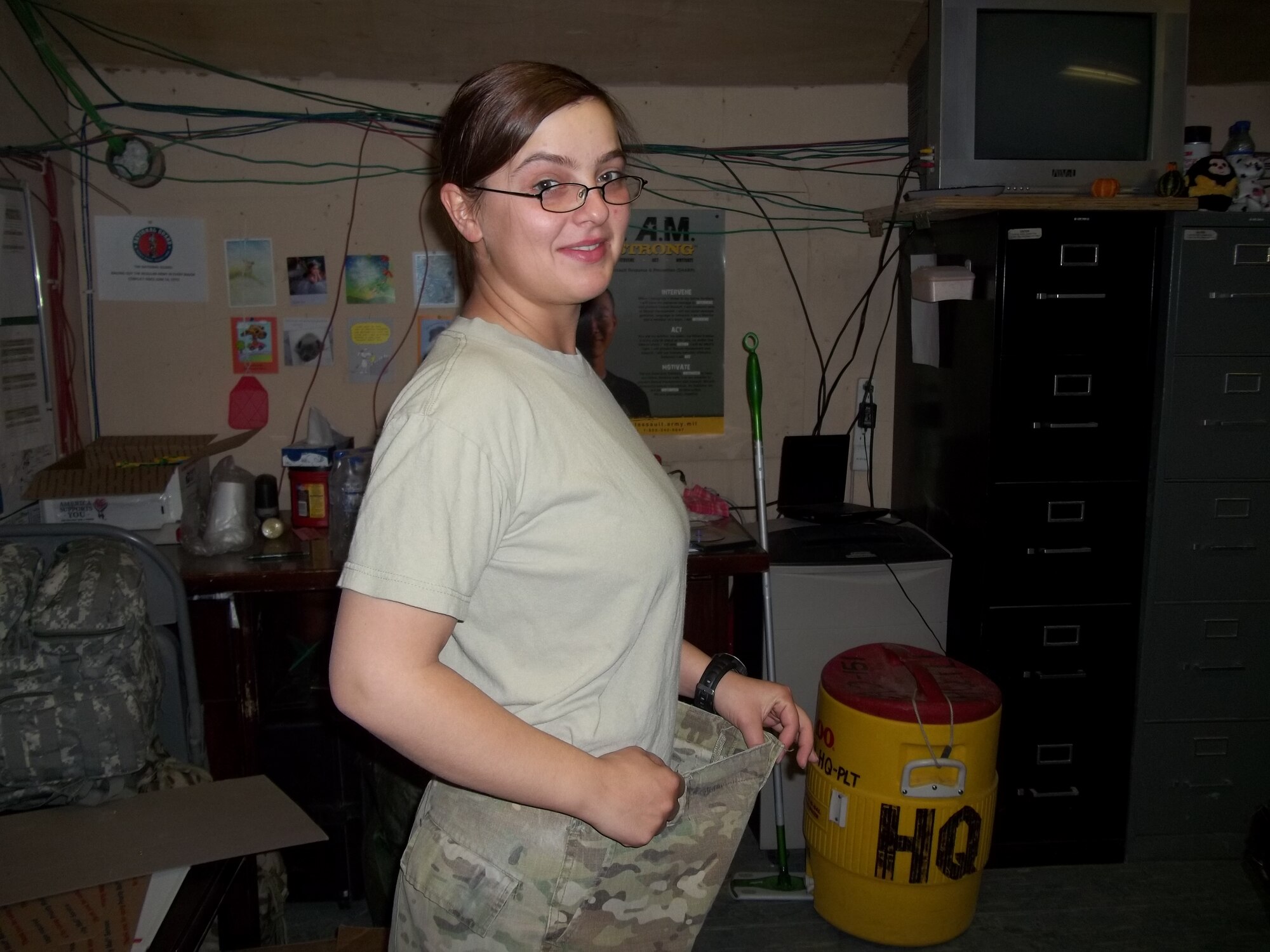Senior Airman Roza Kowal, Provincial Reconstruction Team Paktya supply specialist from Chicago, shows off the weight she has lost during her deployment to Afghanistan, Oct. 20, 2011. With her belt removed from her multi-cam trousers, she depicts what losing 40 pounds looks like. She credits her weight loss toa change in diet and a consistent exercise regimen that includes a lot of running. Since the beginning of her deployment four months ago, Kowal has run more than 250 miles. (Courtesy photo)