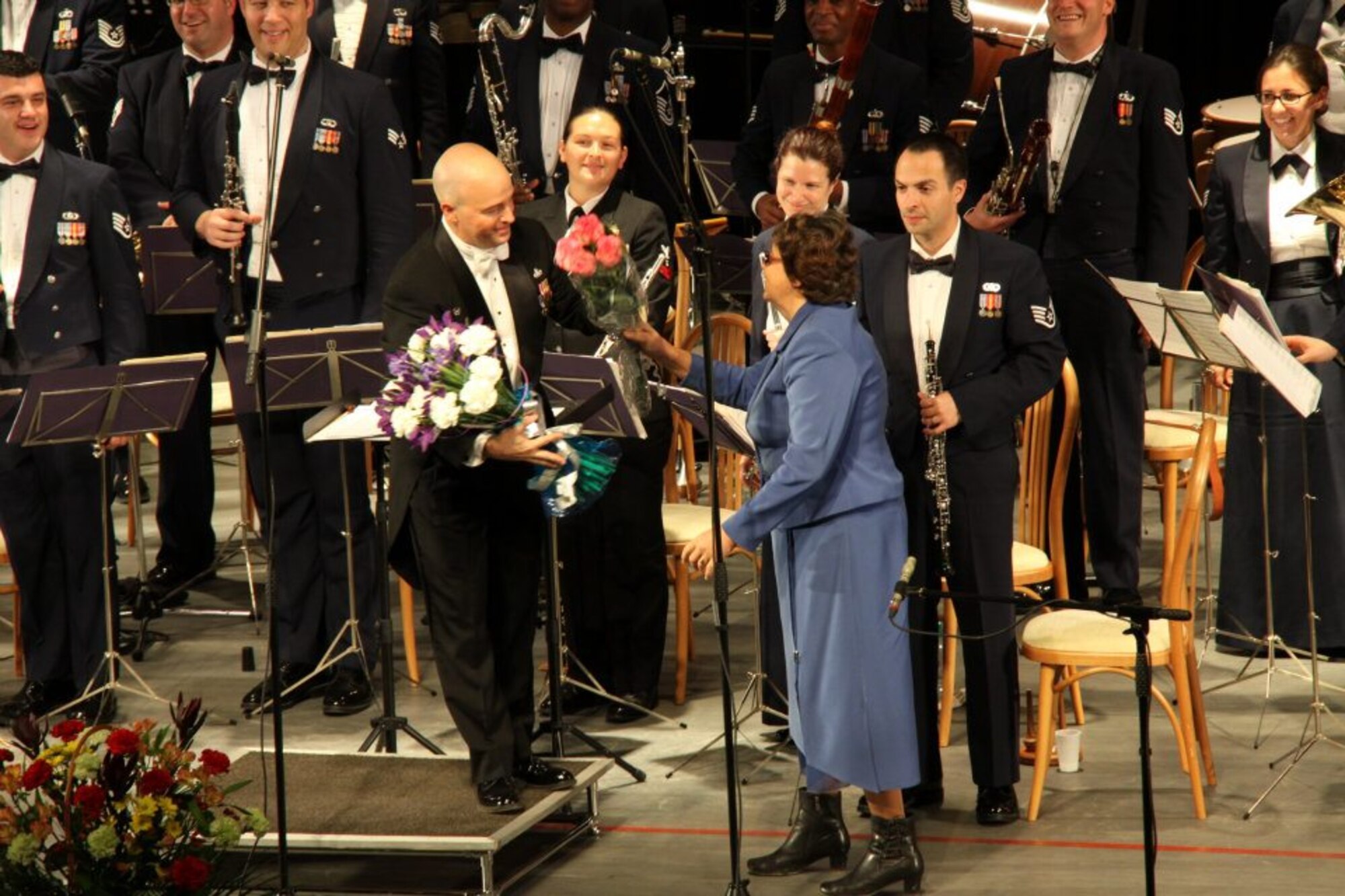 Maj. Matt Henry, U.S. Air Forces in Europe Band commander and music director, receives a flower bouquet from an audience member during a performance by the band at the Philharmonic Hall in Perm, the Russian Federation on Oct. 25, 2011. The USAFE Band was on a 8-day tour of the Western Siberia/Ural region as part of the "American Seasons" bilateral initiative sponsored in part by the U.S. Consulate in Yekaterinburg. (Courtesy photo)
