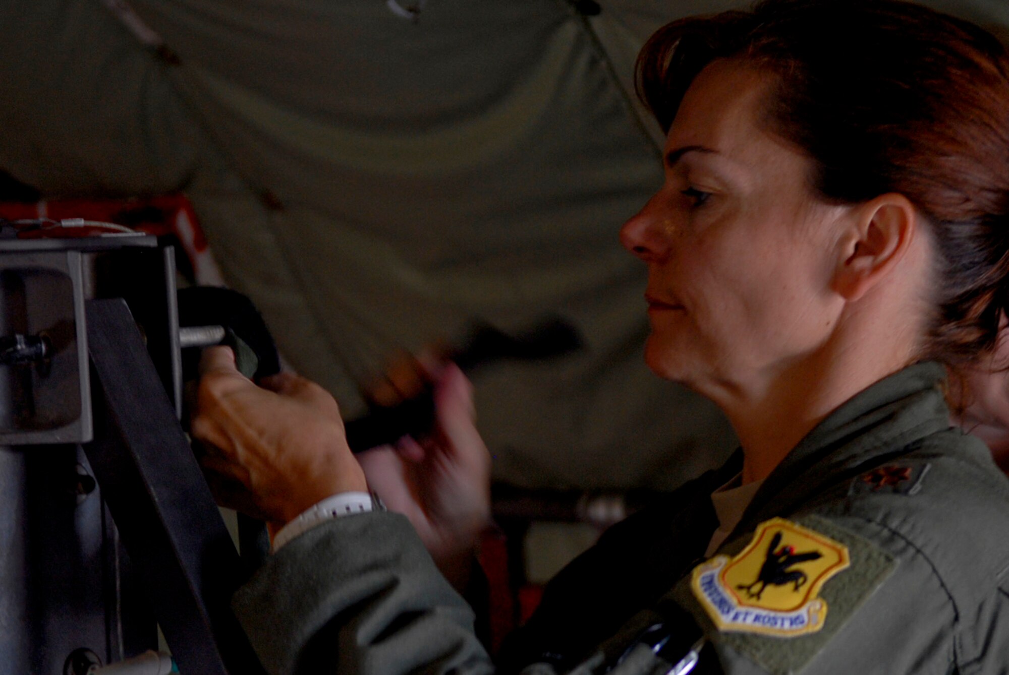 U.S. Air Force Maj. Catherine Ortega, 18th Aeromedical Evacuation Squadron officer in charge of aircrew training, adjusts equipment straps aboard a KC-135 Stratotanker before a mission at Kadena Air Base, Japan, Nov. 2. Ortega recently received the Dolly Vinsant Flight Nurse of the Year Award for operations during her deployment to Kandahar, Afghanistan, as the senior flight nurse for her five-member air evacuation crew. (U.S. Air Force photo/Airman 1st Class Tara A. Williamson/released)
