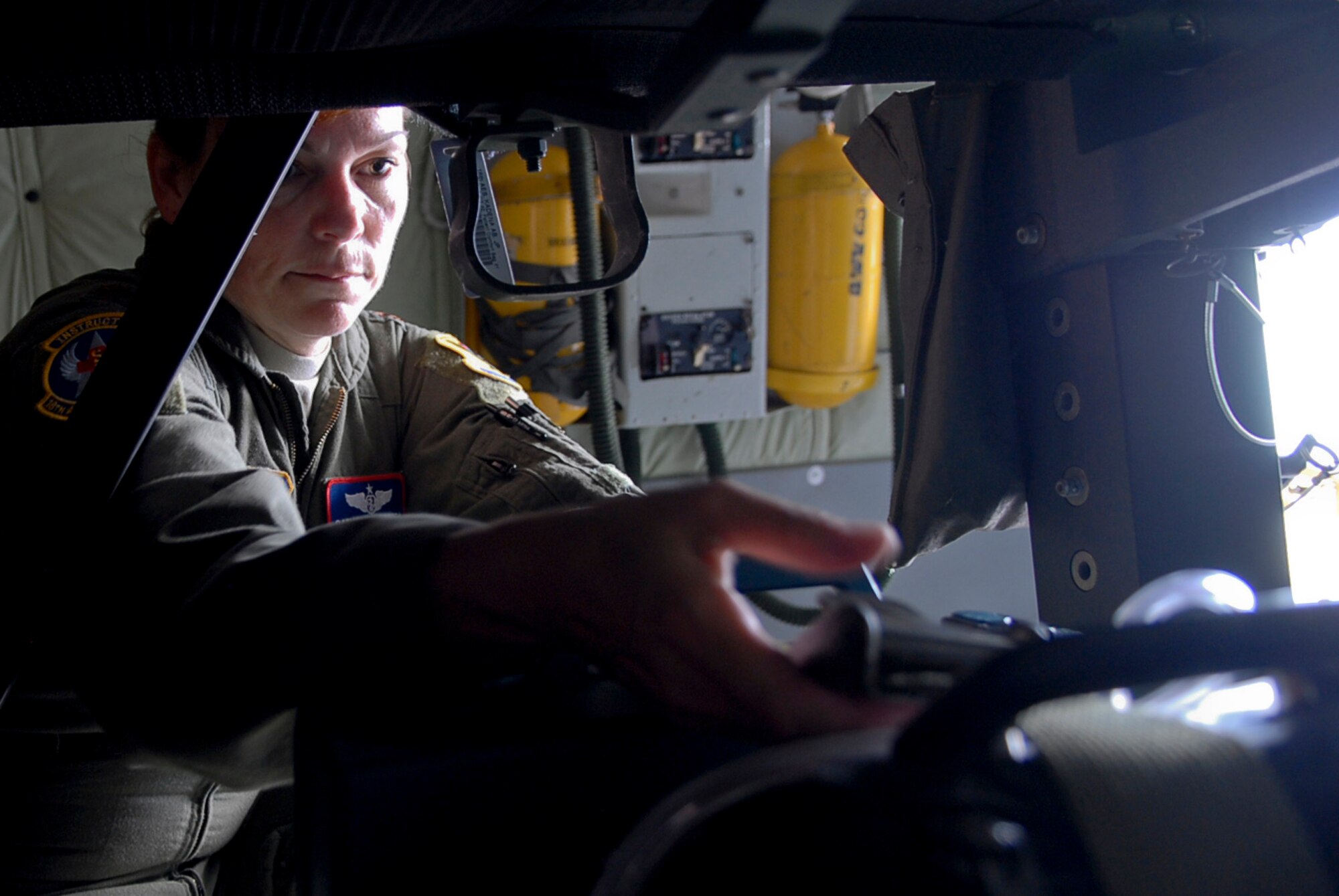 U.S. Air Force Maj. Catherine Ortega, 18th Aeromedical Evacuation Squadron officer in charge of aircrew training, fits the oxygen into place aboard a KC-135 Stratotanker before a mission at Kadena Air Base, Japan, Nov. 2. The major recently received the Dolly Vinsant Flight Nurse of the Year Award for her services while deployed to Kandahar, Afghanistan, as the senior flight nurse for her five-member air evacuation crew. (U.S. Air Force photo/Airman 1st Class Tara A. Williamson/released)
