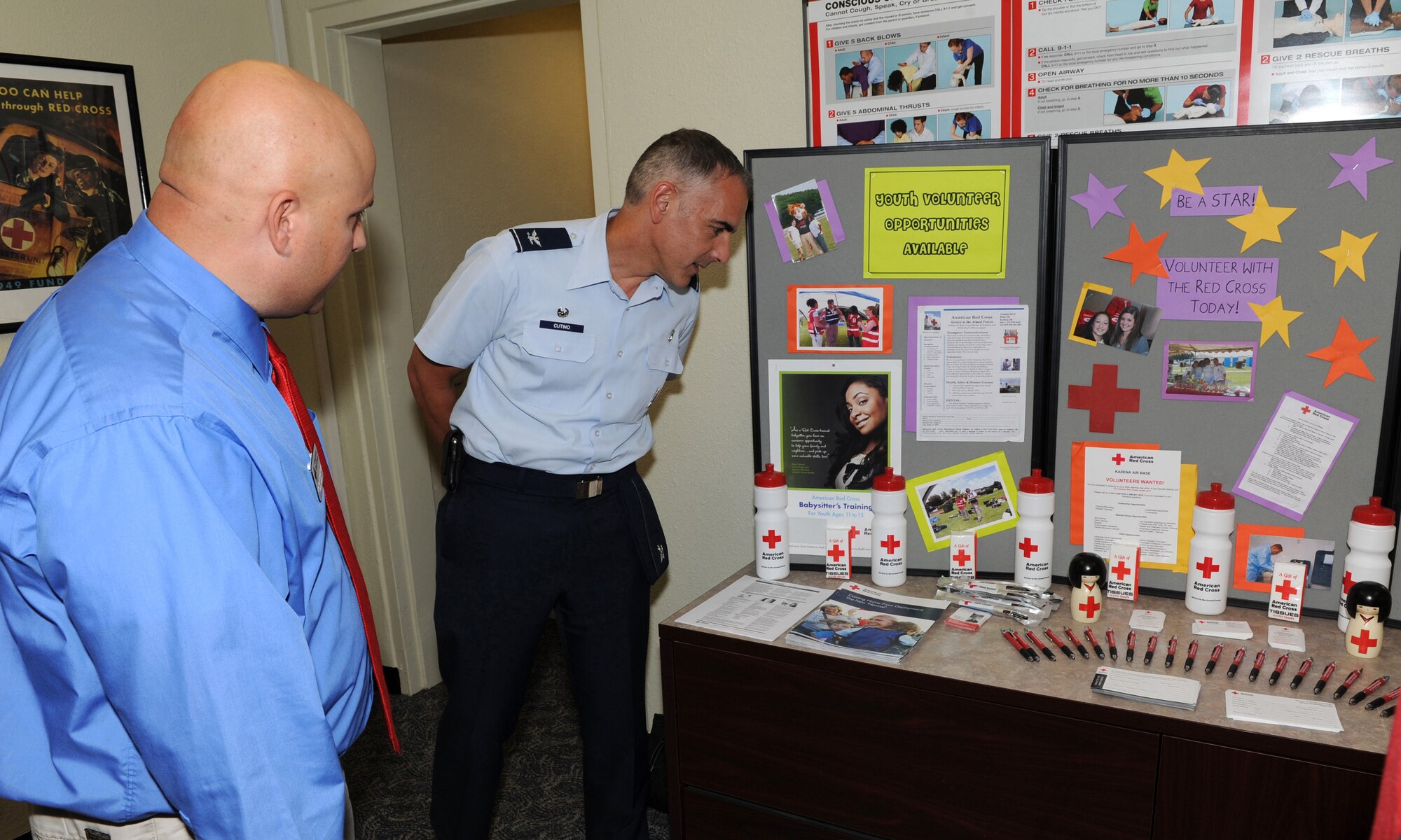 Jason Ramlow, Kadena Red Cross station manager, gives a grand tour of the new KRC facility to U.S. Air Force Col. Salvatore Cutino, 18th Dental Squadron commander, during the KRC open house on Kadena Air Base, Japan, Oct. 31. During the event, participants at the event received a grand tour of the new facility as well as face painting, refreshments and door prizes. (U.S. Air Force photo/Junko Kinjo/released)