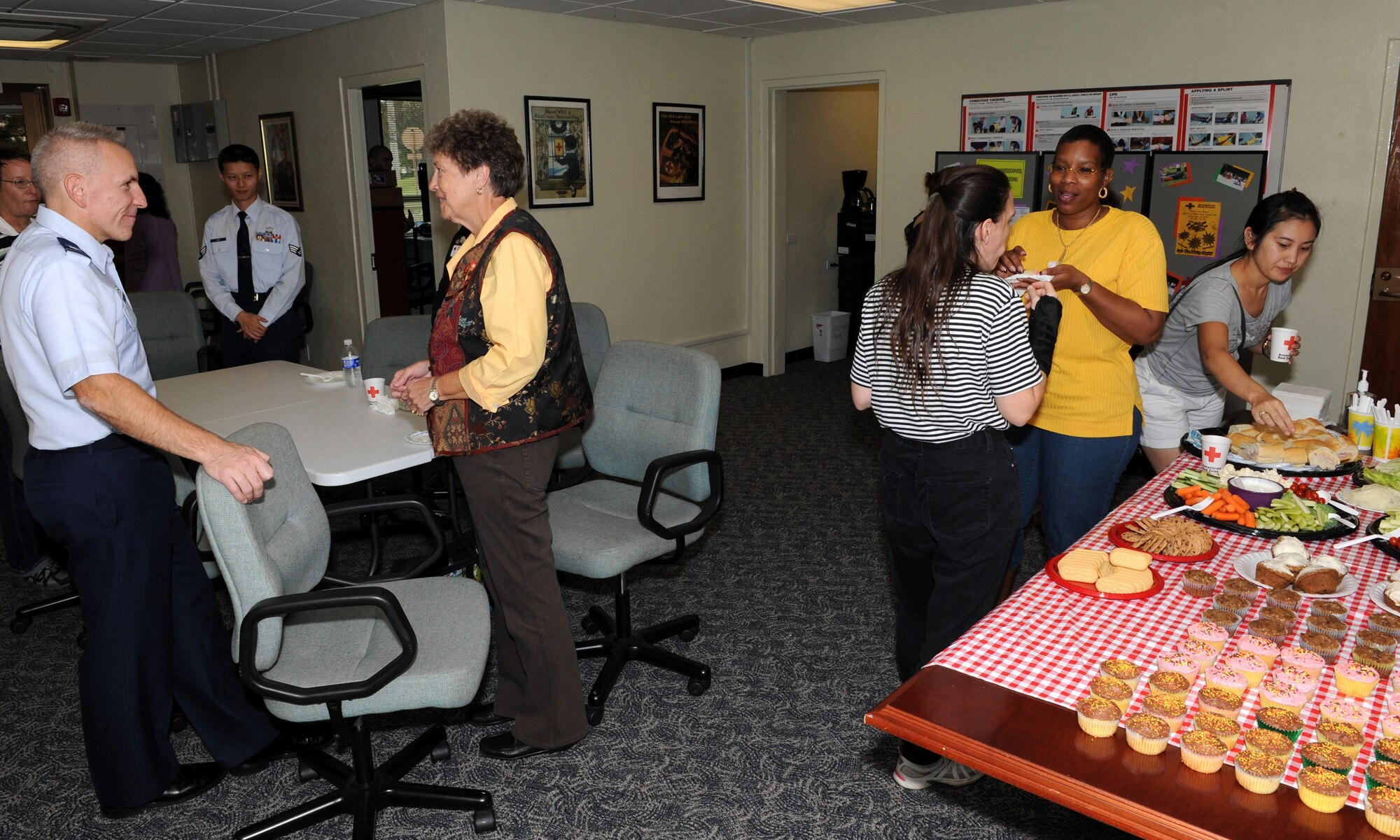 Participants at the Kadena Red Cross open house mingle and enjoy refreshments during the event on Kadena Air Base, Japan, Oct. 31. The KRC hosted the event after moving the facility to a new location Oct. 8. (U.S. Air Force photo/Junko Kinjo/released) 