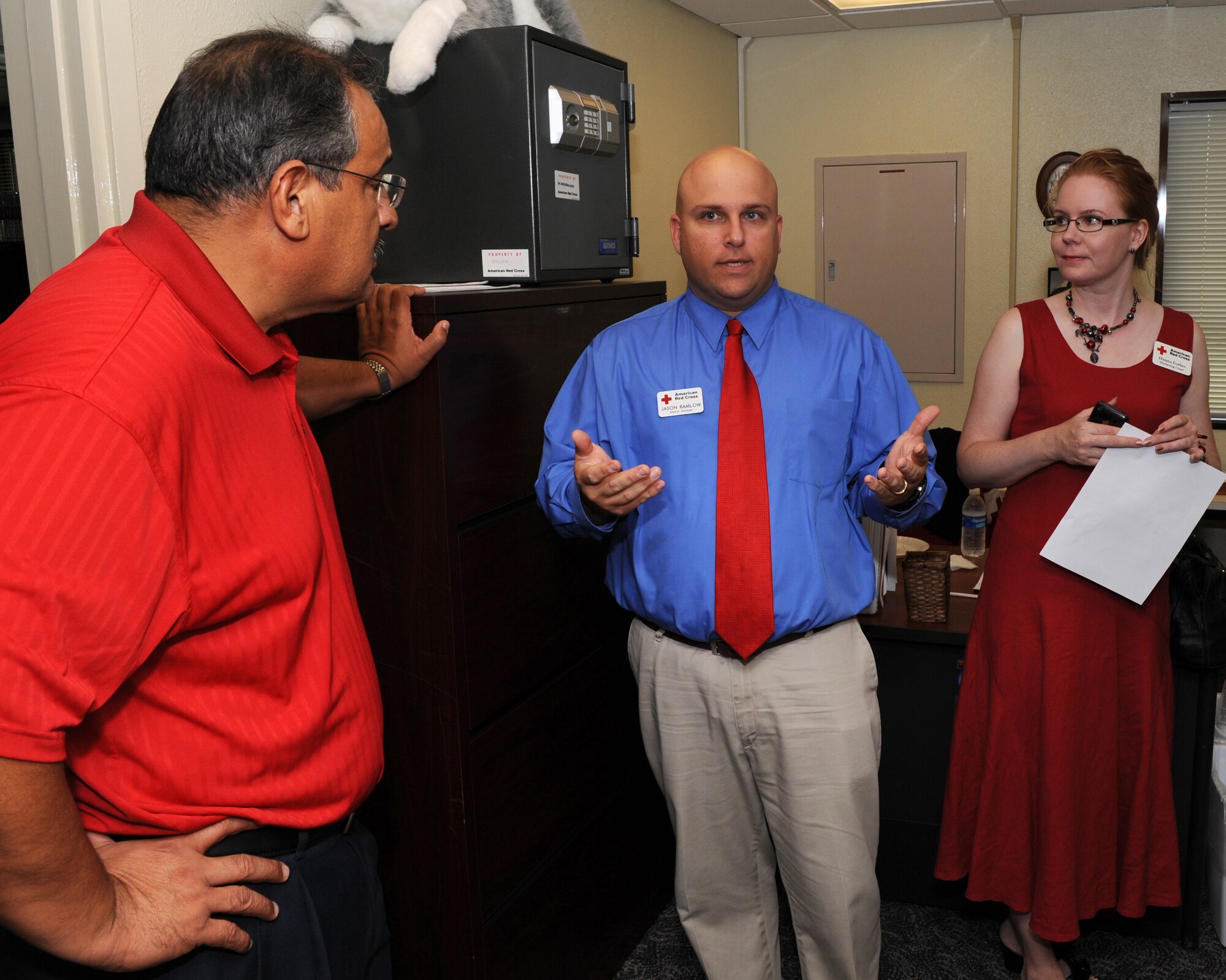 Jason Ramlow, Kadena Red Cross station manager (middle), and Hanna Forbes, marketing chair, give a tour of the new facility to Felipe Jimenez, 18th Mission Support Group deputy director, during the KRC open house on Kadena Air Base, Japan, Oct. 31. Participants at the event received a grand tour of the new facility as well as face painting, refreshments and door prizes. (U.S. Air Force photo/Junko Kinjo/released)