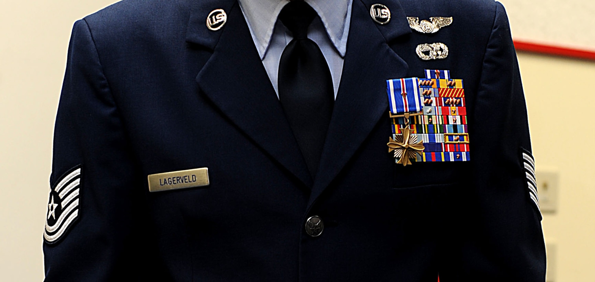 U.S. Air Force Tech. Sgt. Scott Lagerveld, 33rd Rescue Squadron flight engineer, stands for applause after receiving the Distinguished Flying Cross on Kadena Air Base, Japan, Oct. 17. Lagerveld was given this award after helping in the recovery of 13 United States Soldiers and coalition forces. (U.S. Air Force photo/ Airman 1st Class Brooke P. Beers/Released)