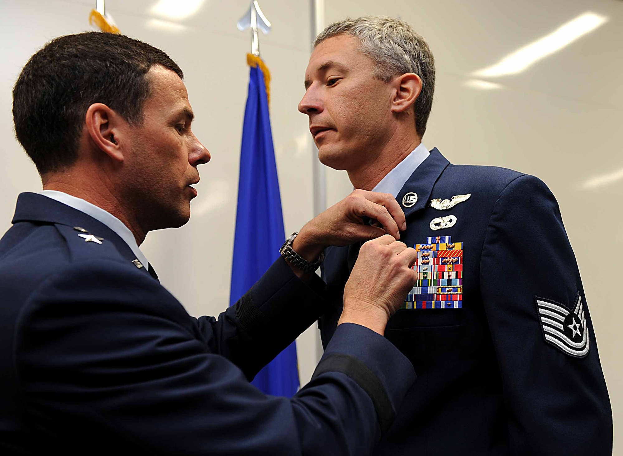 U.S. Air Force Brig. Gen. Matt Molloy, 18th Wing commander, pins a Distinguished Flying Cross on U.S. Air Force Tech. Sgt. Scott Lagerveld, 33rd Rescue Squadron flight engineer, on Kadena Air Base, Japan, Oct. 17. Lagerveld was given this award after helping in the recovery of 13 United States Soldiers and coalition forces. (U.S. Air Force photo/ Airman 1st Class Brooke P. Beers/Released)