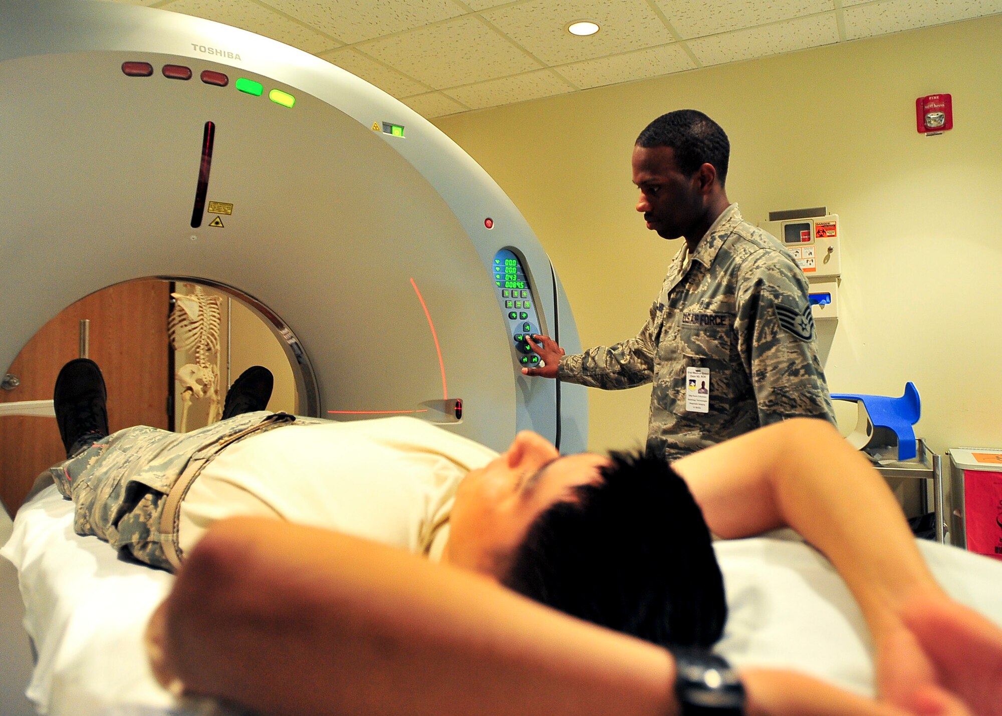 Staff Sgt. Kevin Collymore, 51st Medical Operations Squadron radiology technician, prepares a patient for a Computerized Axial Tomographic scan Nov. 1, 2011. The CAT scan is a type of X-ray that is utilized for diagnostic purposes in a variety of health issues. (U.S. Air Force photo/Senior Airman Adam Grant)