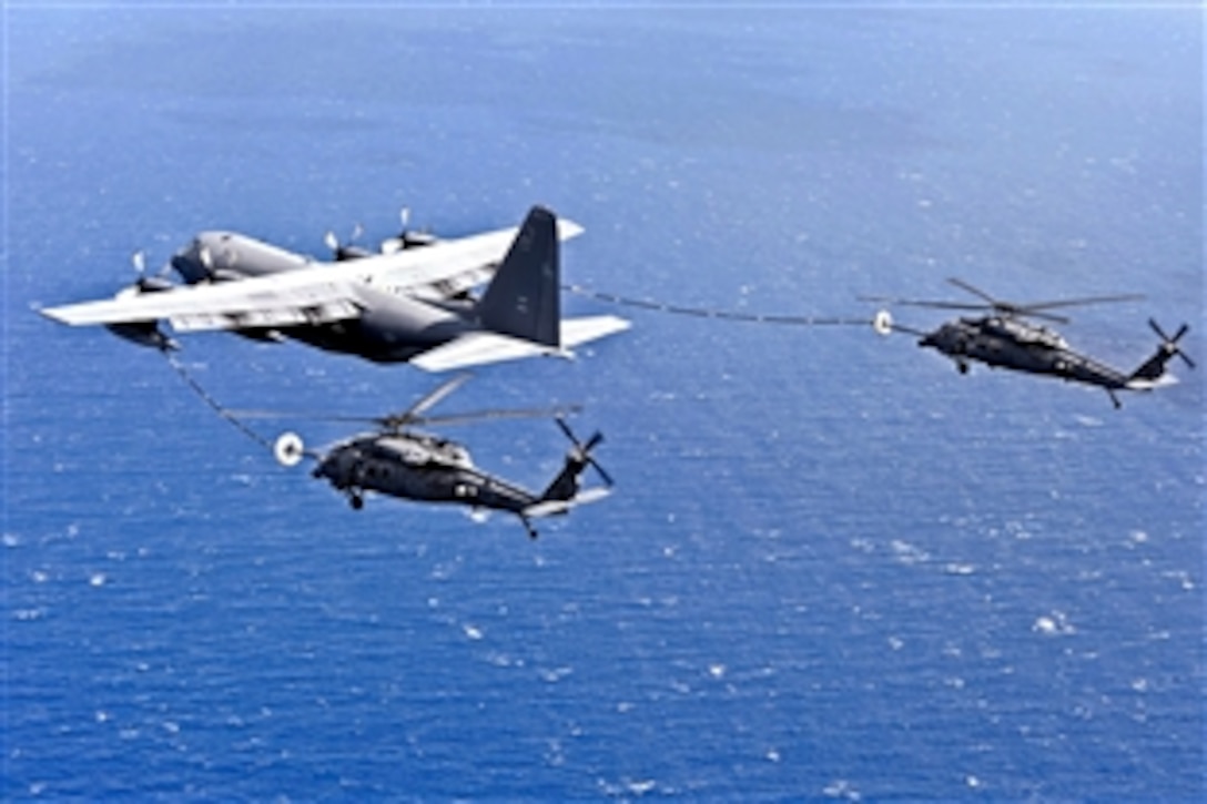 An MC-130P Combat Shadow refuels two HH-60G Pave Hawks as they fly to Osan Air Base, South Korea, during exercise Pacific Thunder, Oct. 27, 2011. The Combat Shadow crew is assigned to the 17th Special Operations Squadron, and the Pave Hawks crew are assigned to the 33rd Rescue Squadron. Pacific Thunder is an annual 10-day exercise.