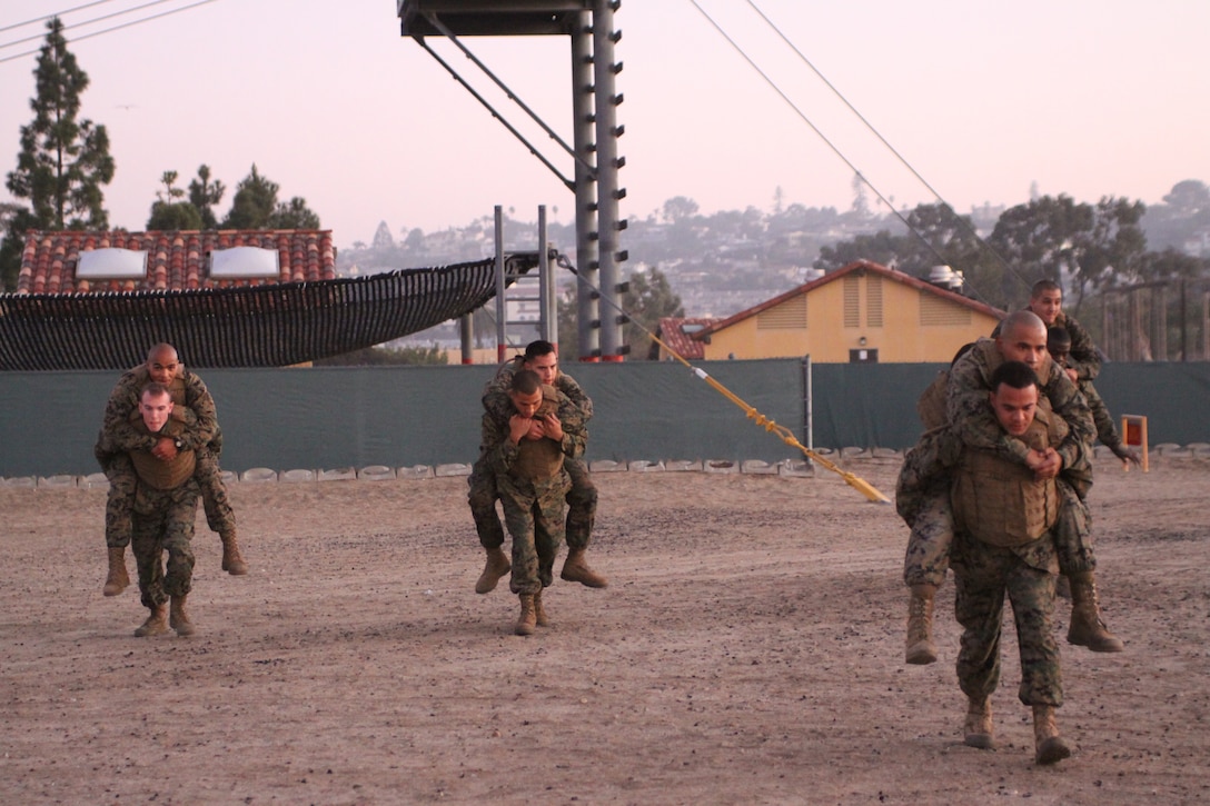 Marines enrolled in the Martial Arts Instructors Course perform various buddy drags and carries during their first field exercise aboard Marine Corps Recruit Depot San Diego. Throughout the course, students will be required to complete two quizzes, two written evaluations, and nine practical evaluations in order to become certified Marine Corps Martial Arts instructors.