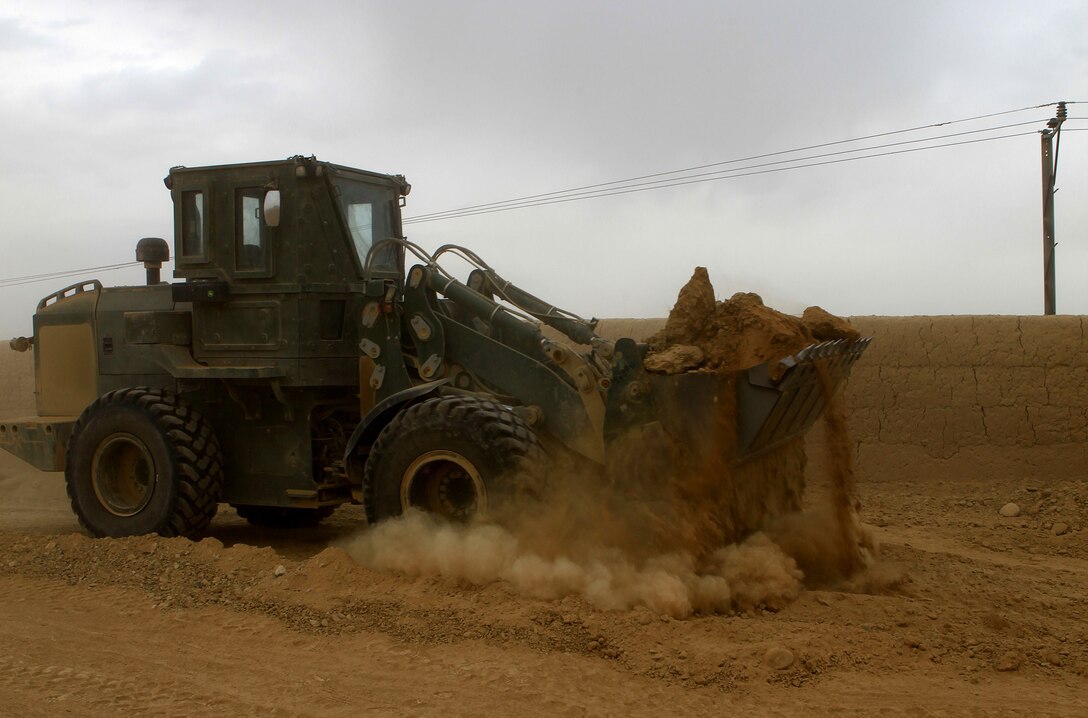 A 7th Engineer Support Battalion, 2nd Marine Logistics Group (Forward), bulldozer lays dirt along Route 611 in Helmand province, Afghanistan, Nov. 3.  Marines with 7th ESB repaired multiple areas of the route as part of support efforts for Operation Eastern Storm.  (U.S. Marine Corps photo by Cpl. Katherine M. Solano)