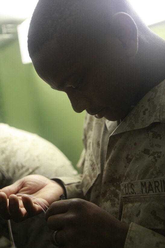 Lance Cpl. Clifford Galashaw, a multichannel communications operator, works with wiremen to install fiber optic strands at Camp Dwyer, Afghanistan, Nov. 3. Galashaw, of Florence, S.C., worked outside of his specialty to support Marine Wing Communications Squadron 28’s fiber optic upgrade at Camp Dwyer. The upgrade will bring more durable and reliable communications to the units at Camp Dwyer.