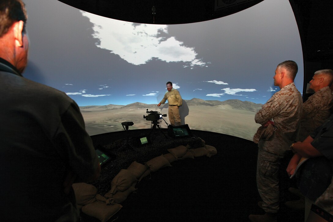 David E. Gaul shows Marine leaders and other virtual trainer staff the capabilities of the supporting arms virtual trainer on Camp Hansen Nov. 3. The SAVT facilitates calling for indirect fire on different types of scenarios. Gaul is an SAVT operator, currently operating out of Camp Pendleton, Calif.