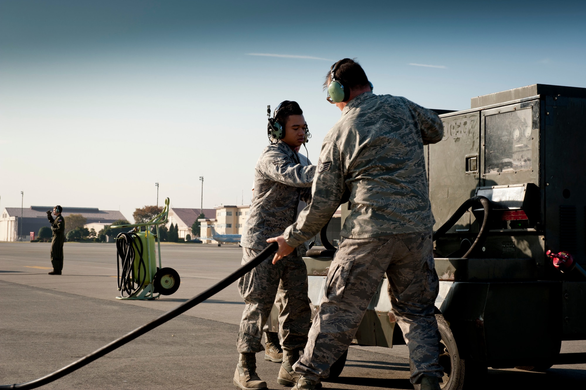 YOKOTA AIR BASE, Japan -- Airmen from the 374th Aircraft Maintenance Squadron, work on a generator in preparation of a Samurai Surge exercise at Yokota Air Base, Japan, Nov. 2, 2011. Maintenance crews prepared six C-130 Hercules to fly formation air drops training missions over Yokota Air Base and a drop zone near Mt. Fuji. (U.S. Air Force photo/Capt. Raymond Geoffroy)