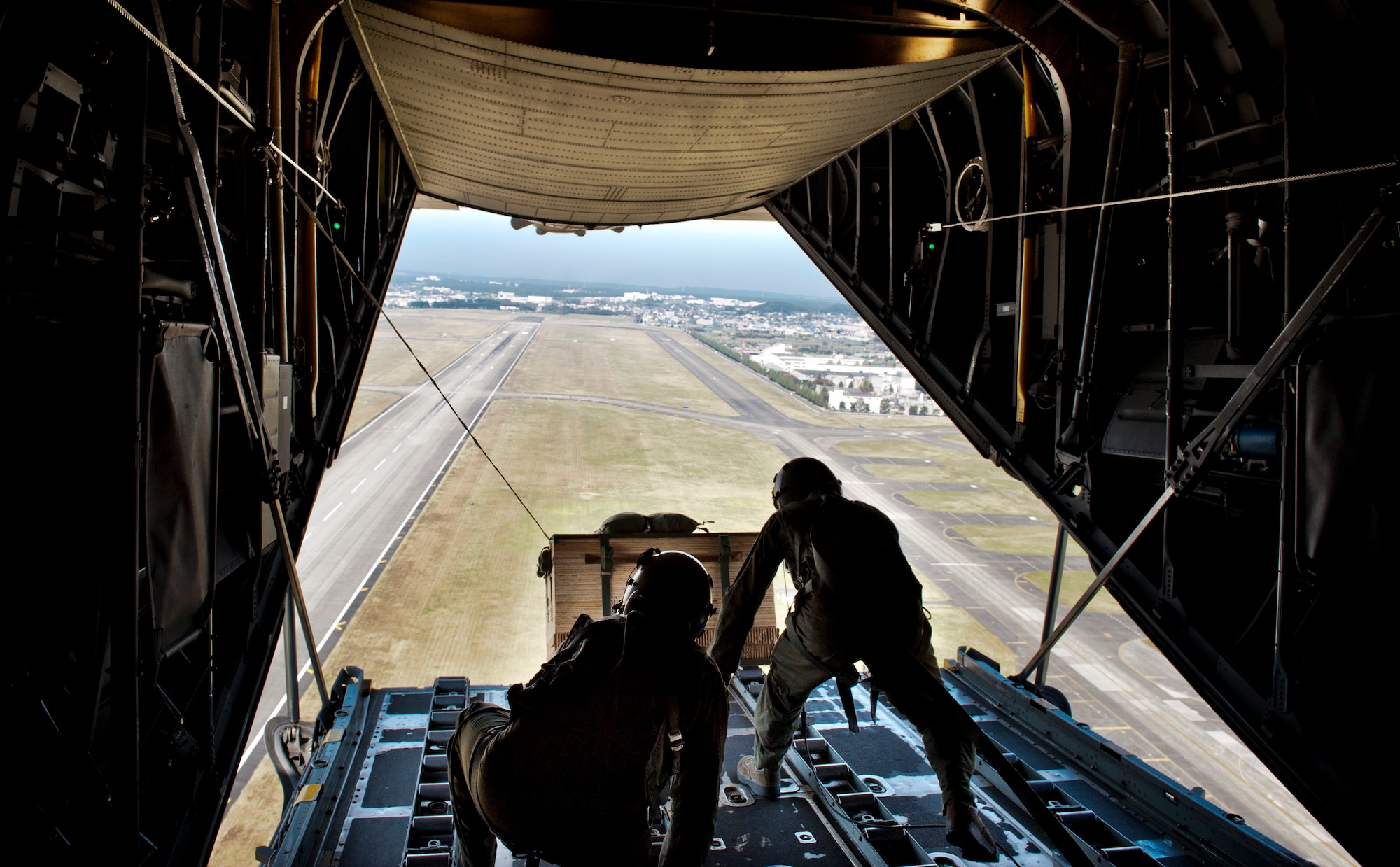 YOKOTA AIR BASE, Japan -- Crew members aboard a C-130 Hercules prepare to deploy a low-cost, low-altitude payload during Samurai Surge over Yokota Air Base, Japan, Nov. 2, 2011. Aircrew from the 36th Airlift Squadron participated in Samurai Surge, an all-day training exercise testing mission capability of many agencies throughout the base. (U.S. Air Force photo/Capt. Raymond Geoffroy)