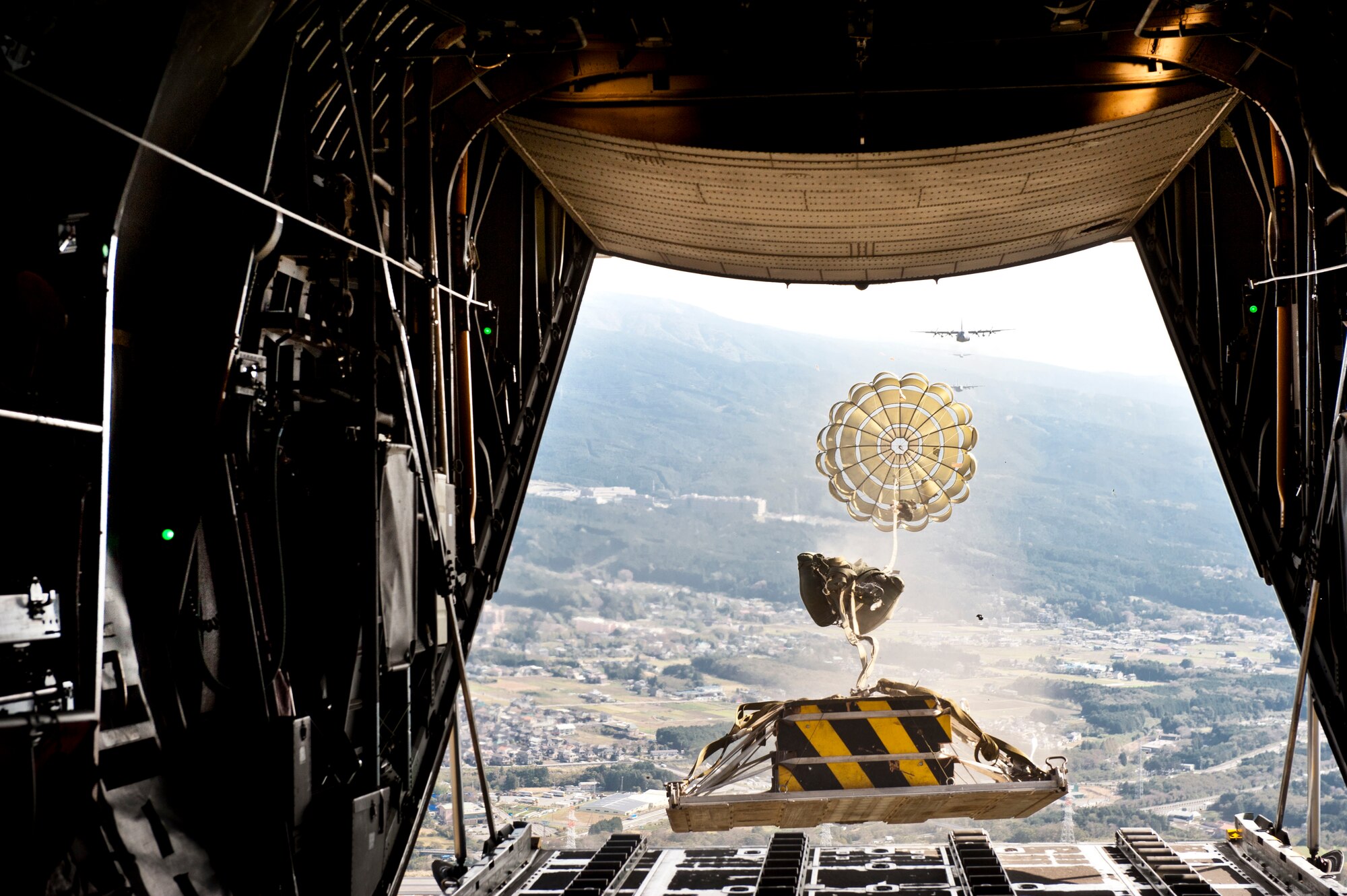 OVER JAPAN -- A heavy payload deploys from the rear of a C-130 Hercules during Samurai Surge near Mount Fuji, Japan, Nov. 2, 2011. Aircrew from the 36th Airlift Squadron participated in Samurai Surge, an all-day training exercise testing mission capability of many agencies throughout the base. (U.S. Air Force photo/Capt. Raymond Geoffroy)