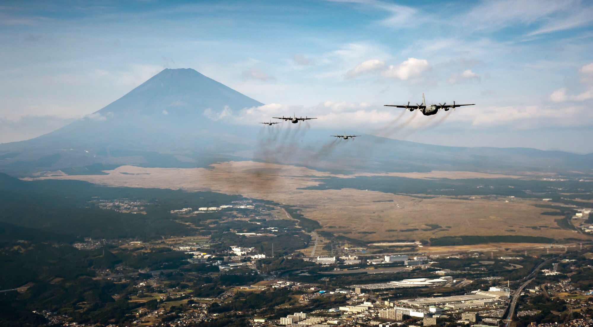 YOKOTA AIR BASE, Japan -- A formation of C-130 Hercules cargo aircraft fly in formation as they return from a training mission near Mount Fuji, Japan, Nov. 2, 2011. Aircrew from the 36th Airlift Squadron participated in Samurai Surge, an all-day training exercise testing mission capability of many agencies throughout the base. (U.S. Air Force photo/Capt. Raymond Geoffroy)