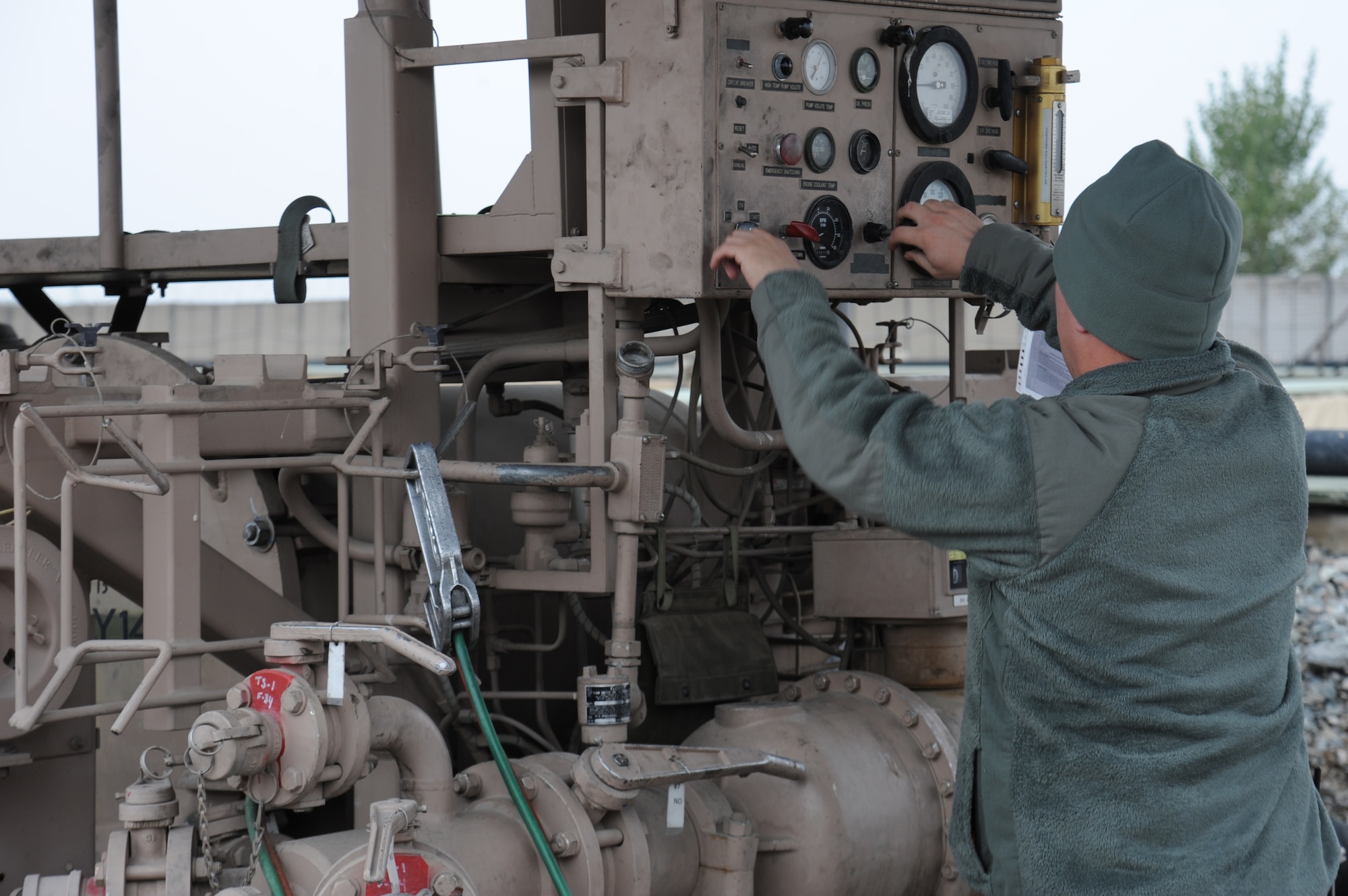 Staff Sgt. Joseph Antee, 376th Expeditionary Logistics Readiness Squadron fuels specialist, adjusts pump settings to refill his 6,000-gallon fuel truck at the Transit Center at Manas, Kyrgyzstan, Nov. 1. The fuel yard contains 22 bladders containing more than 4.2 million gallons of aircraft fuel. Antee is deployed from the 2nd Logistics Readiness Squadron at Barksdale Air Force Base, La. (U.S. Air Force photo/Tech. Sgt. Hank Hoegen) 