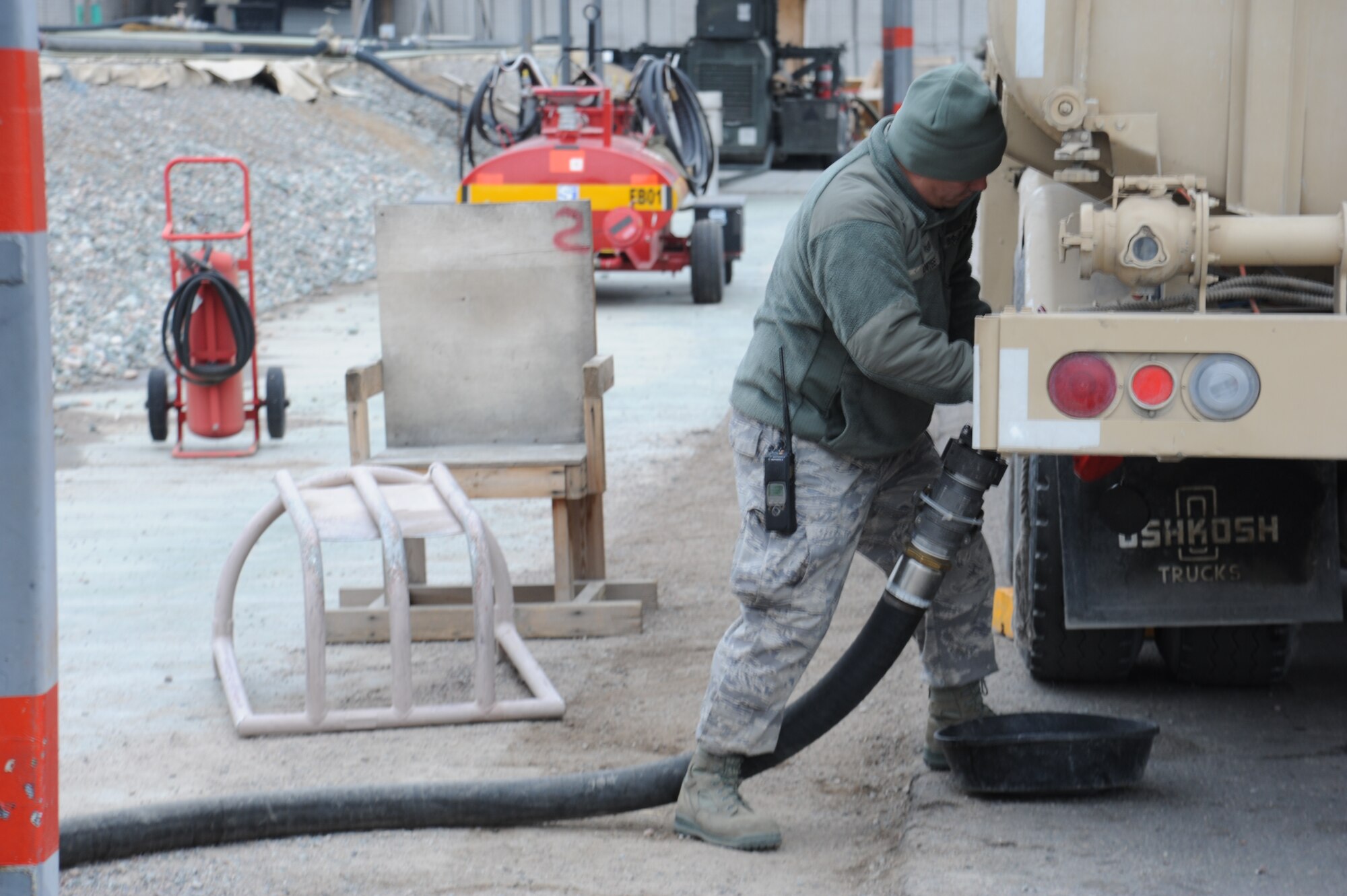 Staff Sgt. Joseph Antee, 376th Expeditionary Logistics Readiness Squadron fuels specialist, connects an R-11 fuel truck to a pump to refill his truck at the Transit Center at Manas, Kyrgyzstan, Nov. 1. The fuel yard contains 22 bladders, each containing more than 200,000 gallons of aircraft fuel. Antee is deployed from the 2nd Logistics Readiness Squadron at Barksdale Air Force Base, La. (U.S. Air Force photo/Tech. Sgt. Hank Hoegen)