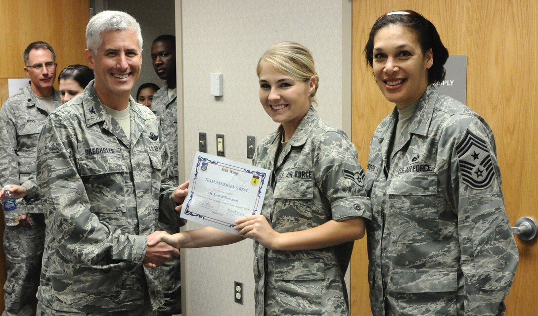 ANDERSEN AIR FORCE BASE, Guam—Airman 1st Class Kendall Thompson, 36th Medical Group emergency medical services technician, receives the Team Andersen’s Best award from Col. Donald Drechsler, 36th Wing vice commander, here Oct. 27. Each week, supervisors nominate a member of their team for outstanding performance and the wing commander presents the selected Airman/Civilian with an award. (U.S. Air Force photo by Senior Airman Benjamin Wiseman/Released)