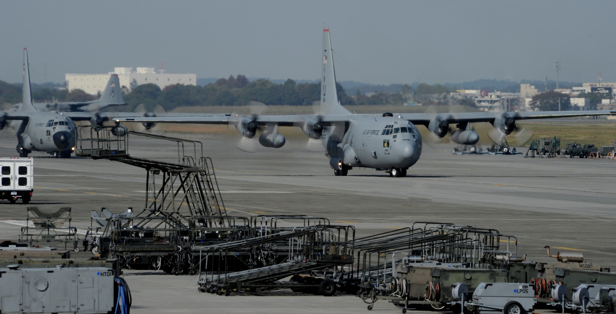 YOKOTA AIR BASE, Japan -- Four of the six C-130 Hercules taxi in preparation for take-off during the Samurai Surge exercise, Yokota Air Base, Japan, Nov. 2, 2011. Aircrew from the 36th Airlift Squadron participated in Samurai Surge, an all-day training exercise testing mission capability of many agencies throughout the base. (U.S. Air Force photo/Staff Sgt. Stacy Moless)