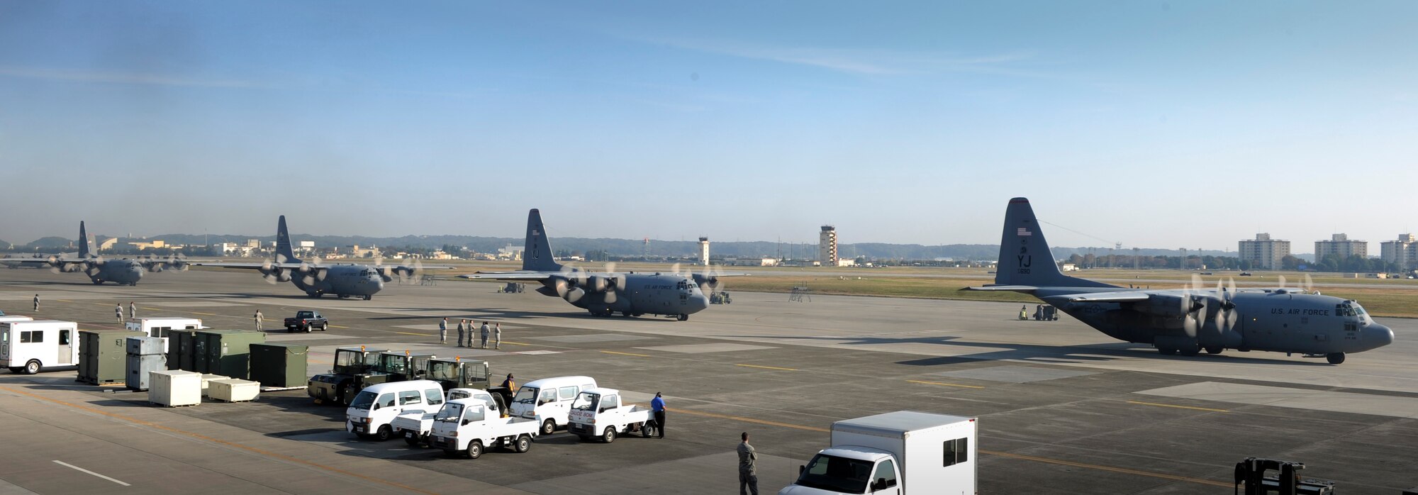 YOKOTA AIR BASE, Japan -- Four of the six C-130 Hercules taxi in preparation for take-off during the Samurai Surge exercise, Yokota Air Base, Japan, Nov. 2, 2011. Aircrew from the 36th Airlift Squadron participated in Samurai Surge, an all-day training exercise testing mission capability of many agencies throughout the base. (U.S. Air Force photo/Staff Sgt. Stacy Moless)