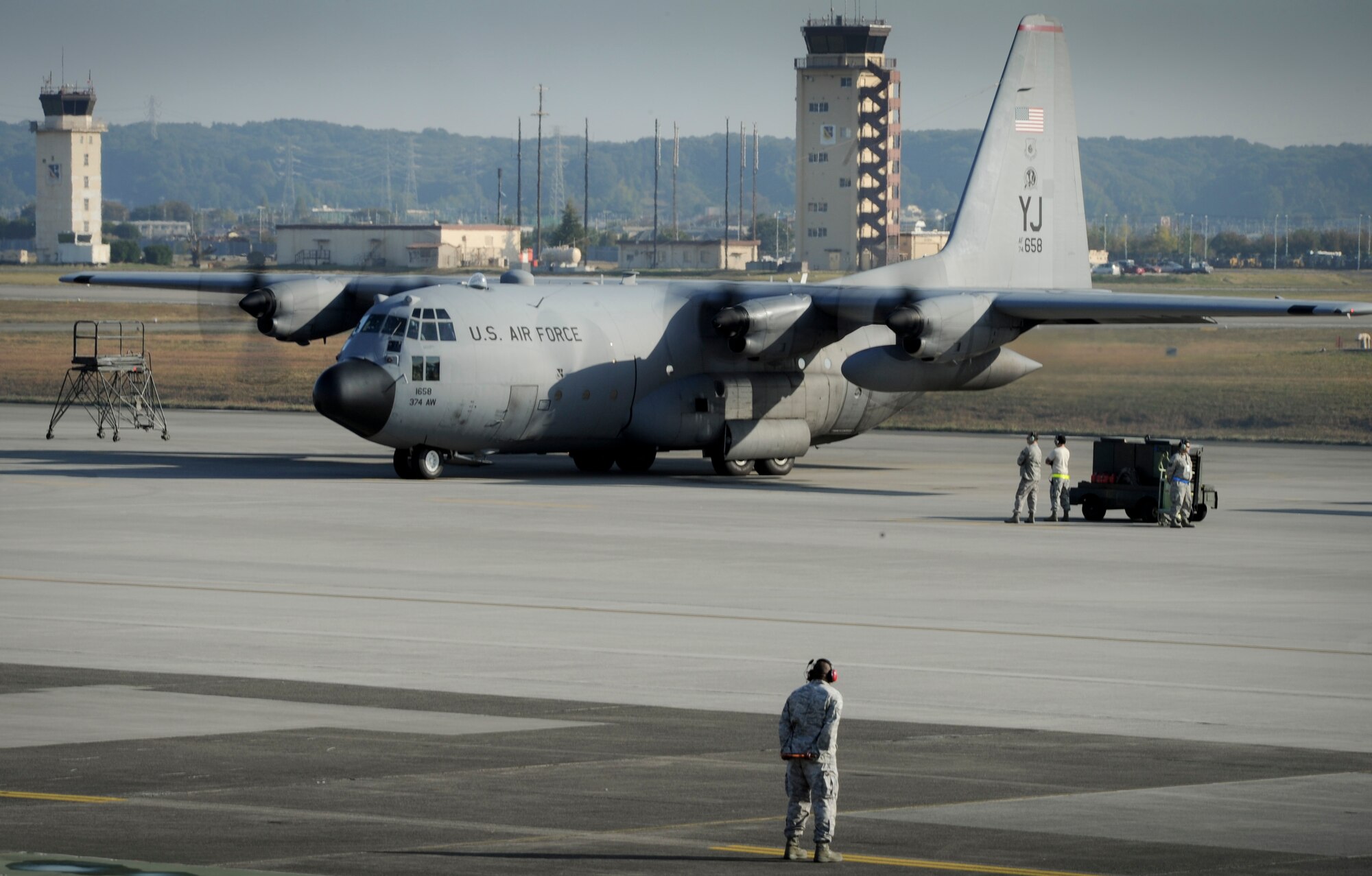 YOKOTA AIR BASE, Japan -- One of the six C-130 Hercules simultaneously starts its engines and prepares to fly in formation and demonstrated its airdrop and large formation capabilities, Yokota Air Base, Japan, Nov. 2, 2011. Aircrew from the 36th Airlift Squadron participated in Samurai Surge, an all-day training exercise testing mission capability of many agencies throughout the base. (U.S. Air Force photo/Staff Sgt. Stacy Moless)