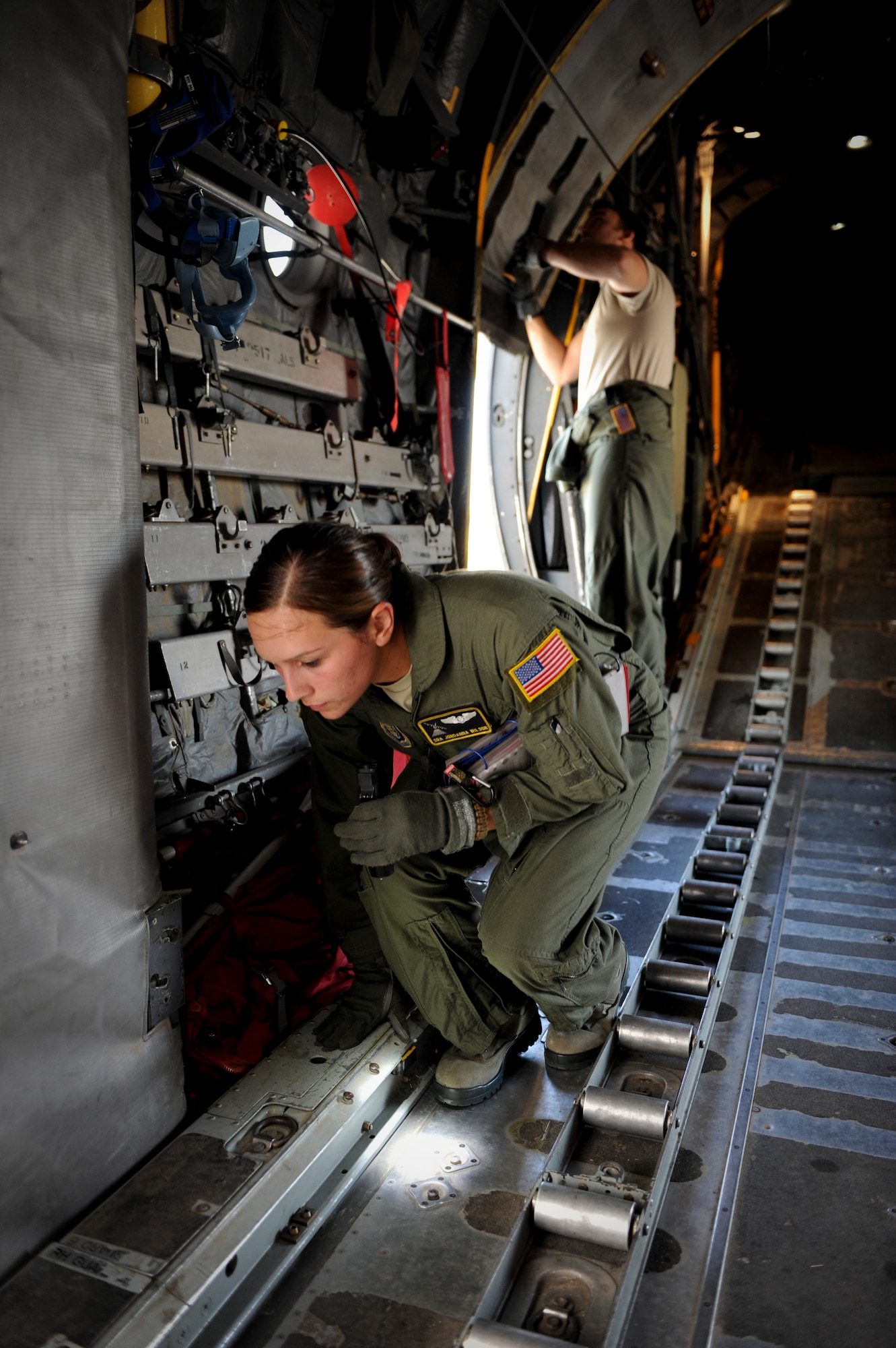 YOKOTA AIR BASE, Japan -- Senior Airman Jordanna Wilson and Technical Sgt. Jonathan Paszkot, 36th Airlift Squadron performs preflight checks on a C-130 Hercules, Yokota Air Base, Nov. 1, 2011. Aircrew from the 36th Airlift Squadron participated in Samurai Surge, an all-day training exercise testing mission capability of many agencies throughout the base. (U.S. Air Force photo/Staff Sgt. Stacy Moless)
