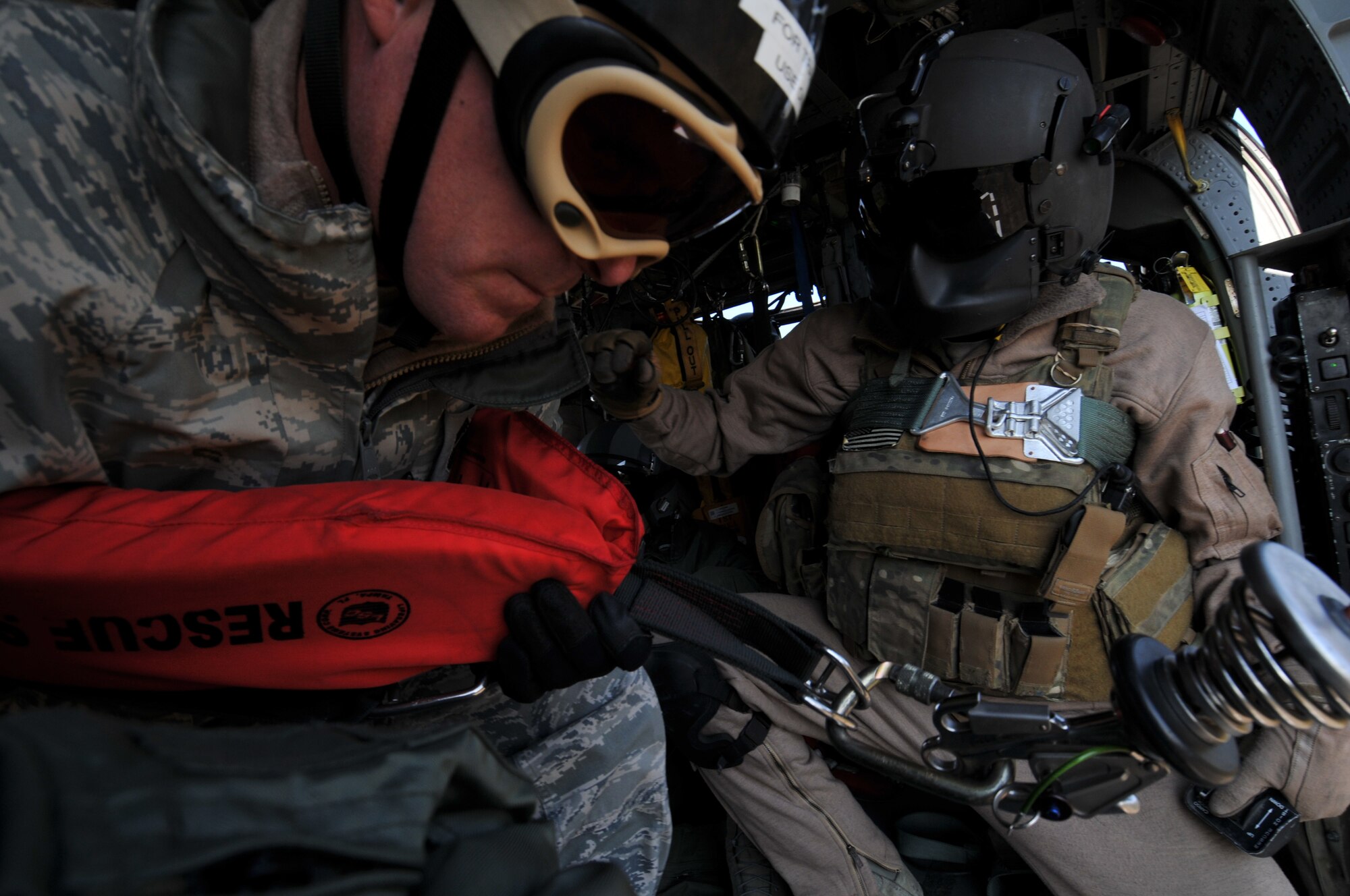 U.S. Air Force Chief Master Sgt. Jeremy Ravlin, 33rd Helicopter Maintenance Unit, prepares to hoist down from the helicopter with the assistance of U.S. Air Force Staff Sgt. Brandon Taylor, 33rd Rescue Squadron HH-60G Flight Engineer, both from Kadena Air Base, Japan, during exercise PACIFIC THUNDER Nov. 1, 2011 near Osan Air Base, Korea.

PACIFIC THUNDER is a 10-day exercise, from Oct. 31-Nov. 09, at Osan AB, Korea involving the 33rd Rescue Squadron, Kadena AB, Japan, and the 25th Fighter Squadron, Osan AB, Korea. These units work together to practice Combat Search and Rescue tactics to prepare for real-world emergency situations. 
(U.S. Air Force photo/Tech. Sgt. Angelique Bilog/released)
